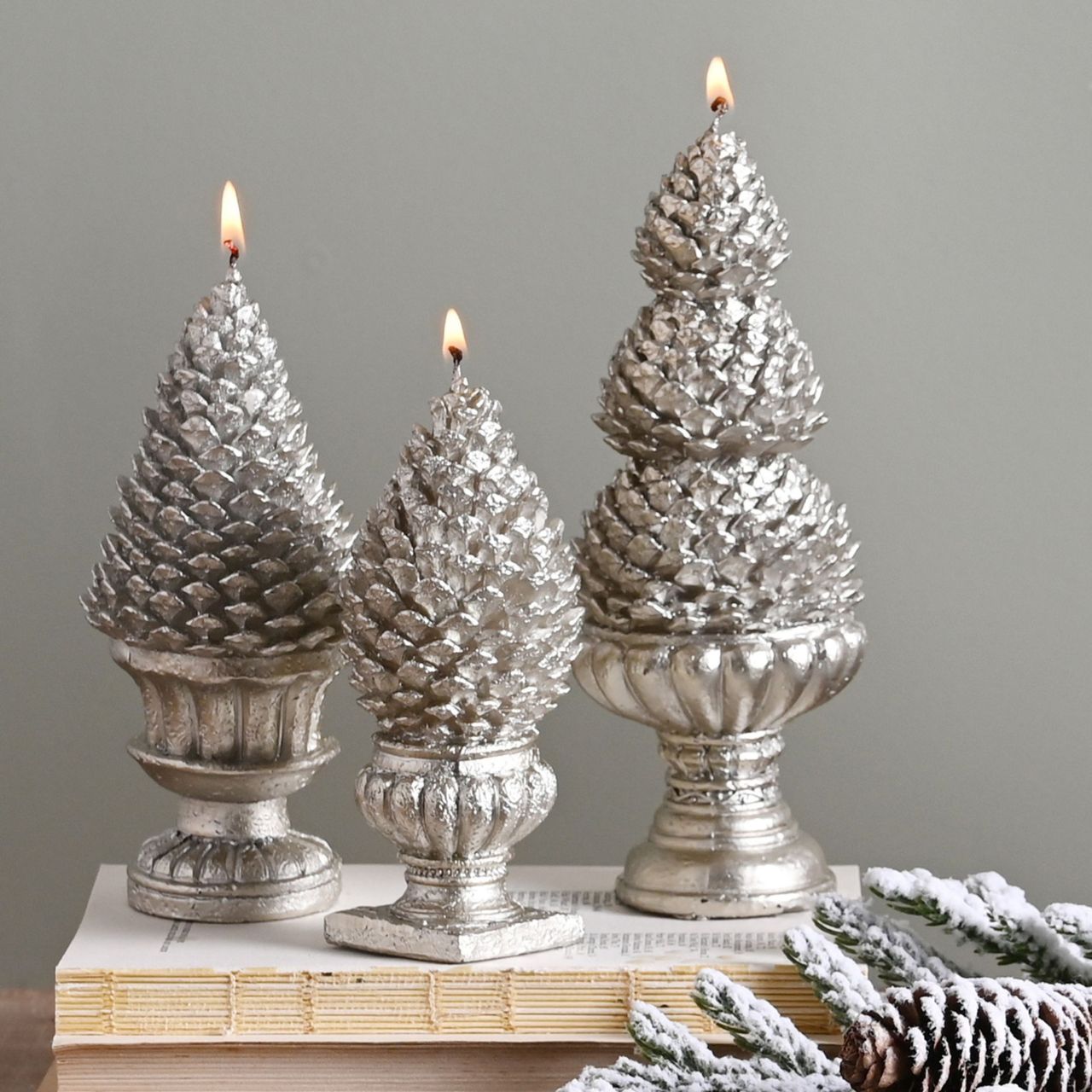 Silver Pinecone Christmas Candles Set  A set of 3 silver pinecone candles by THE SEASONAL GIFT CO.  These standout candles will help to create a magical Winter Wonderland at home when lit during the festive period.