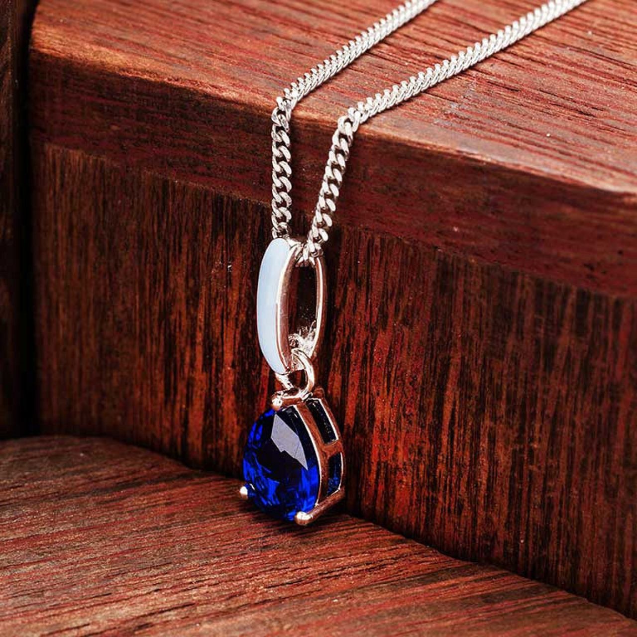 Elevate your elegance with the ShanOre Sterling Silver Necklace, featuring a stunning sapphire CZ centerpiece accented by delicate blue enamel detailing.