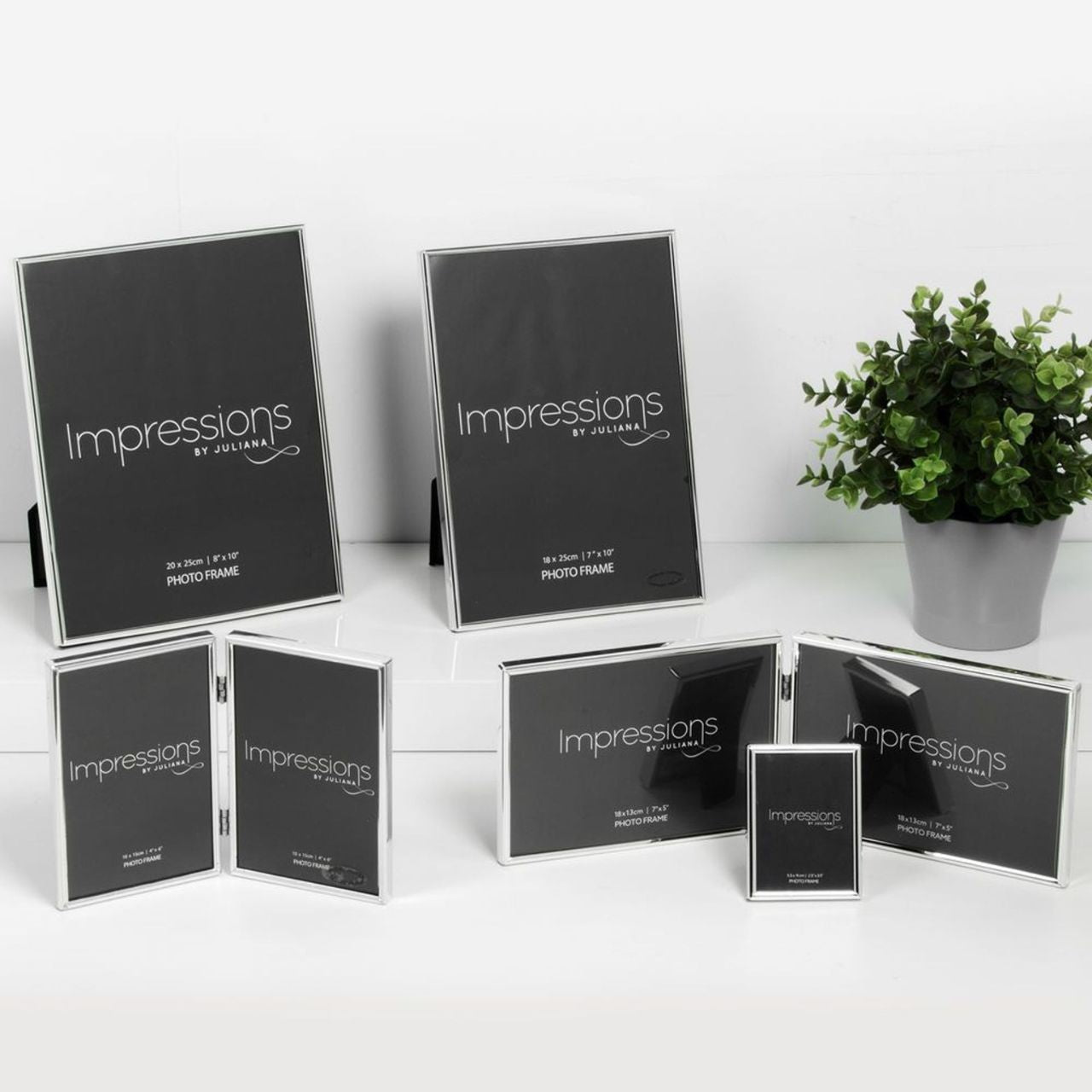 An elegant silver plated triple 5" x 7" aperture hinged photo frame from IMPRESSIONS by Juliana. Complete with wall hooks and black velveteen backing.