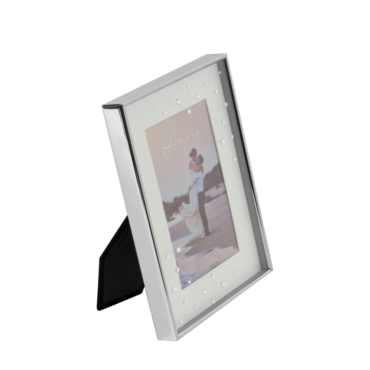 A beautiful silver plated box frame with 4" x 6" (10x15cm) aperture from the AMORE BY JULIANA® Wedding Day Collection. The frame features a crisp white mount and the glass is embellished with a spray of crystals. Complete with standing strut.