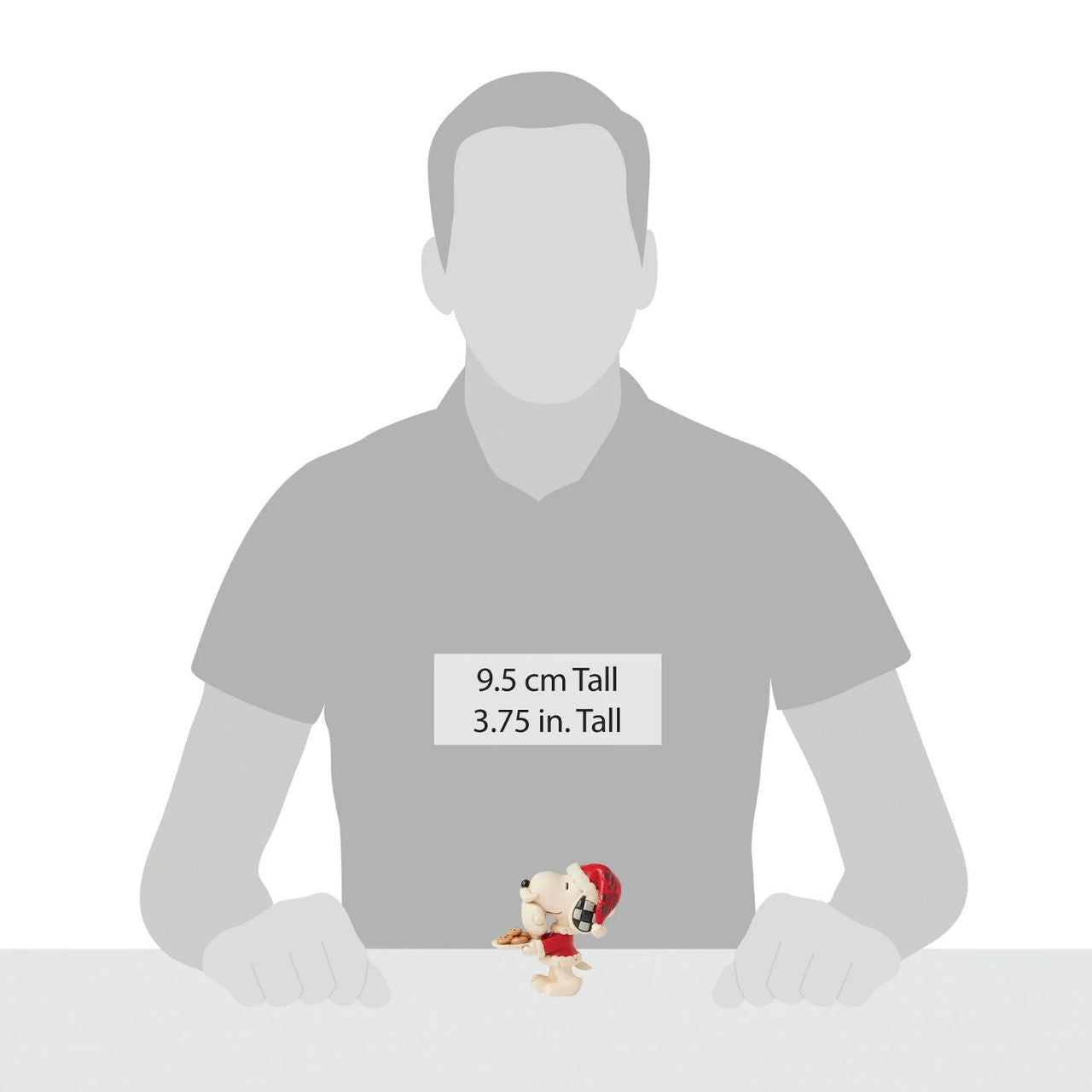 Add a touch of festive cheer to your holiday collection with this miniature Jim Shore design of Snoopy dressed as a cheerful elf. Holding a candy cane and sporting a bright smile, Snoopy embodies the joy of the season in delightful detail.