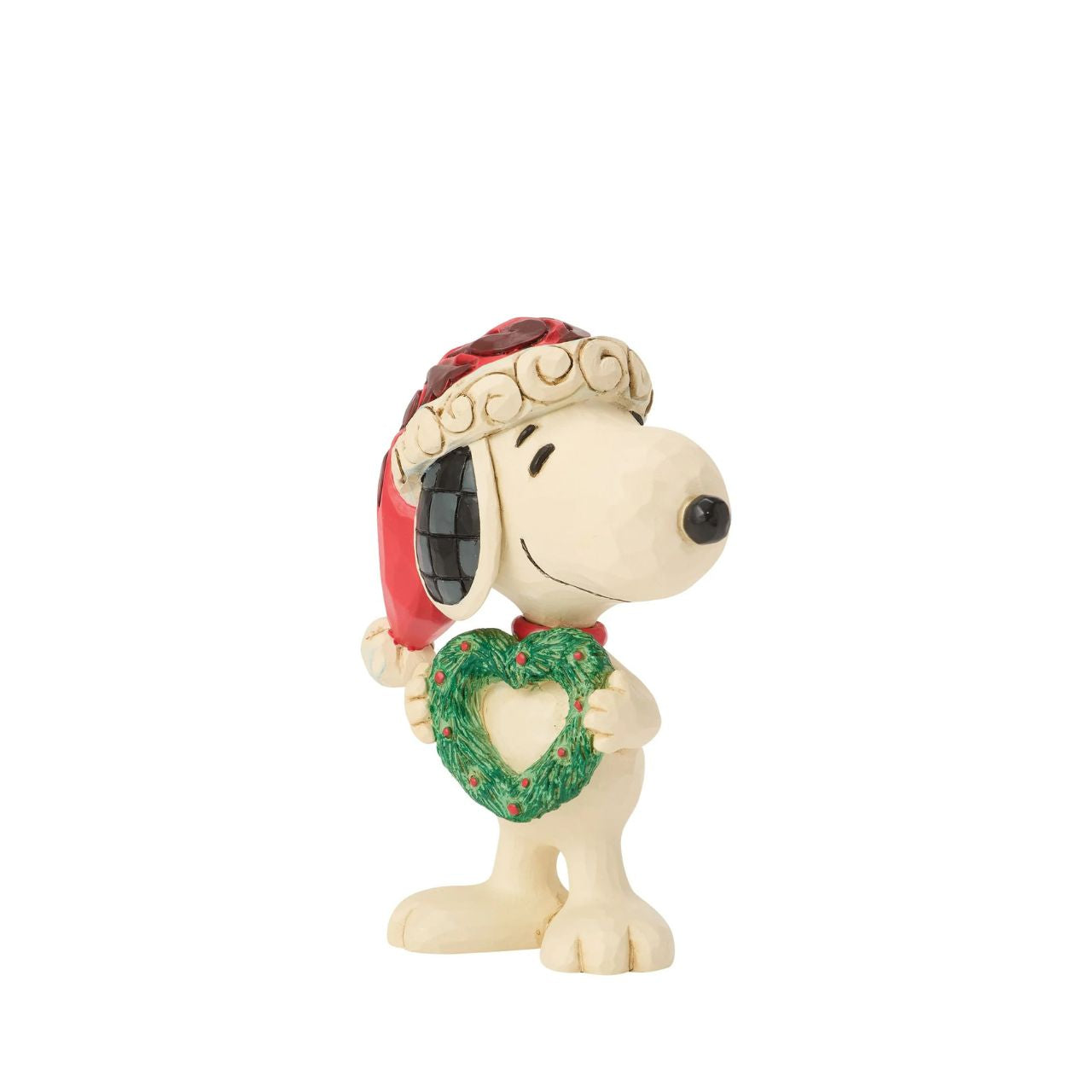 Snoopy holds a heart-shaped wreath in a Santa hat in this darling Jim Shore figurine. Small yet full of holiday charm, it celebrates friendship and Peanuts nostalgia with Christmas warmth.