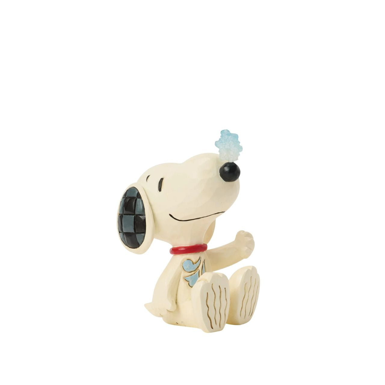 Snoopy balances a delicate snowflake on his nose in this sweet Jim Shore mini. Full of playful charm, it's a whimsical nod to snowy days and the magic of winter. Celebrate your holiday season with the magic of the Peanuts.
