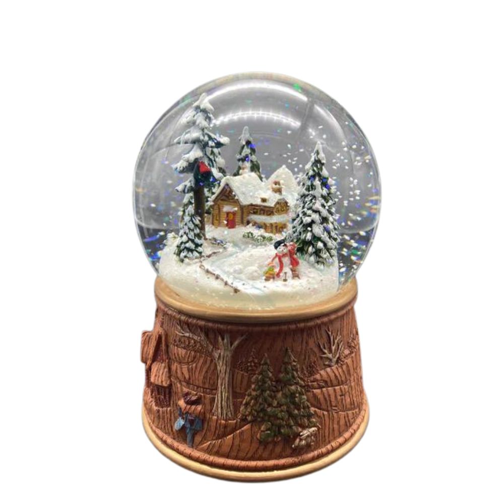 Snow globe made of poly stone. In the 100 mm globe is a small, snow-covered house hidden between snowy hills and fir trees. Next to it are two small children building a snowman.