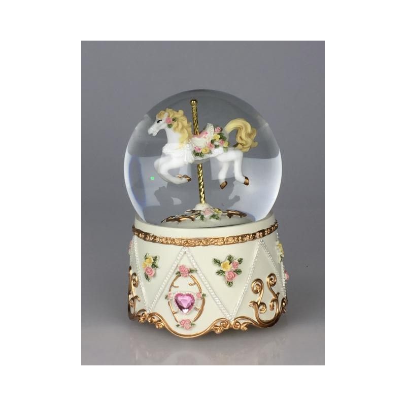 Glitter globe with carousel horse. The decorated carousel horse stands on a gold-coloured pole in the globe filled with glitter. The floor and the base are decorated with flowers, tendrils and ornaments. Shiny stones are attached to the base.