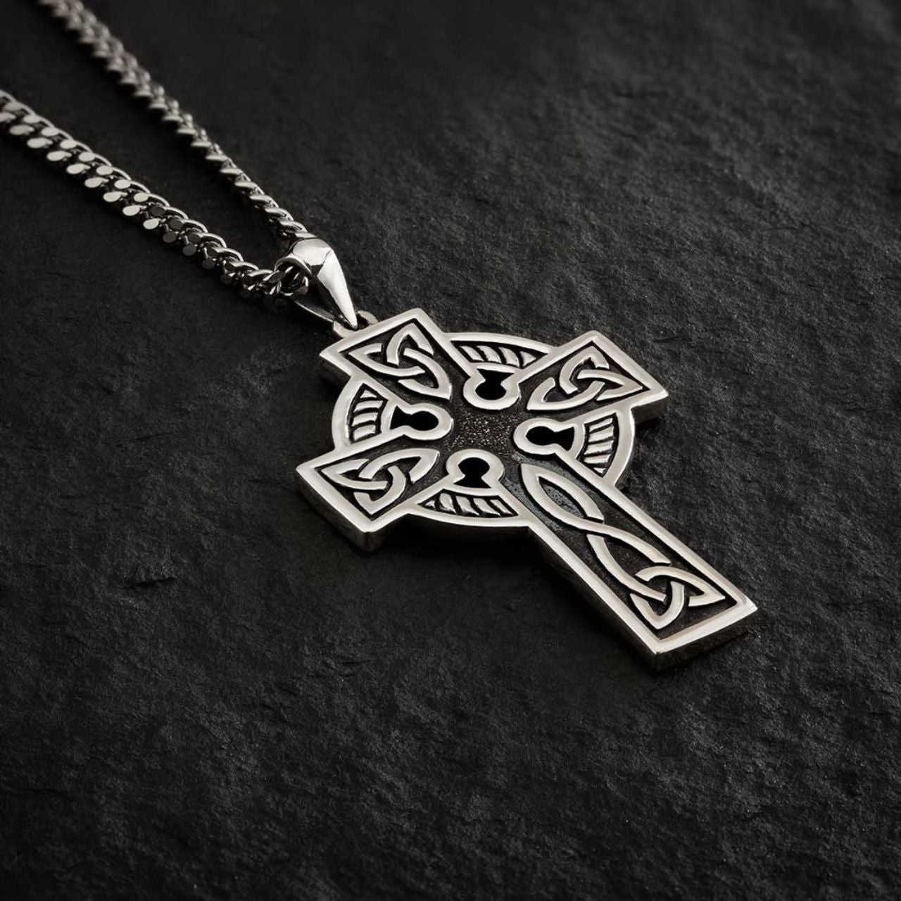 This double-sided Celtic cross pendant is crafted from sterling silver and oxidised to give the necklace an aged look. The colour of the oxidised part of the necklace may vary, resulting in slight differences between the pendant shown and the one you'll receive.