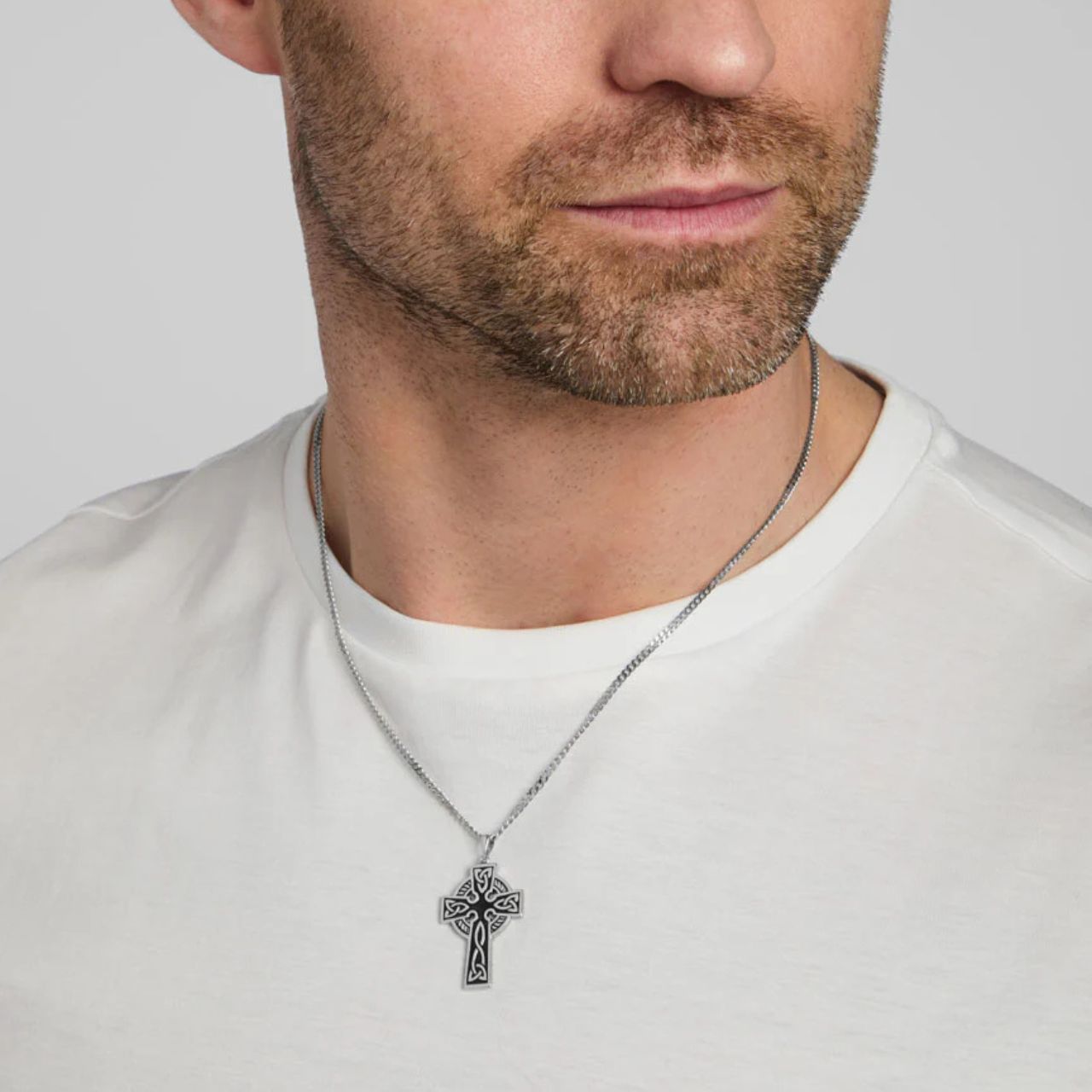 This double-sided Celtic cross pendant is crafted from sterling silver and oxidised to give the necklace an aged look. The colour of the oxidised part of the necklace may vary, resulting in slight differences between the pendant shown and the one you'll receive.