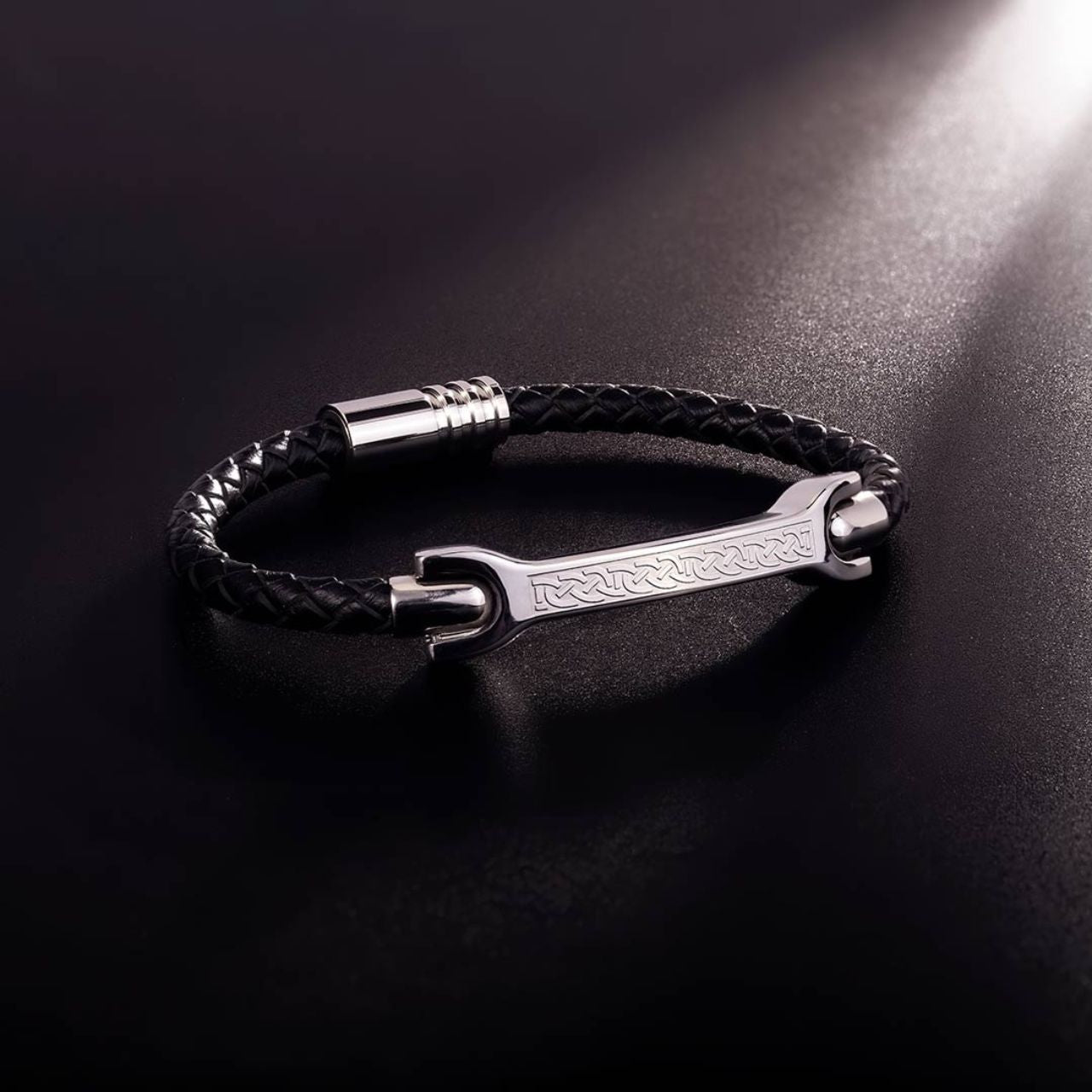 This unique piece for men features a steel plate with a black leather bracelet engraved with Celtic knot-work on the front. There is a magnetic clasp allowing for easy putting on and taking off.