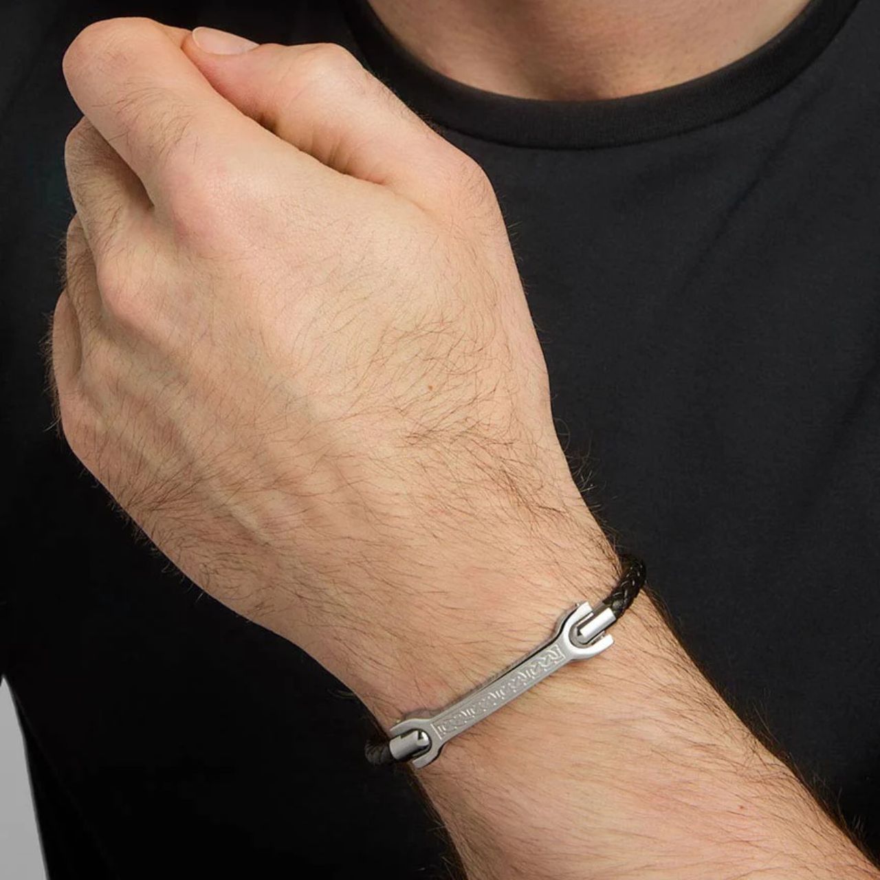 This unique piece for men features a steel plate with a black leather bracelet engraved with Celtic knot-work on the front. There is a magnetic clasp allowing for easy putting on and taking off.