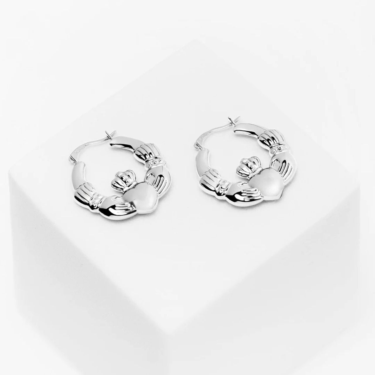 These chunky Claddagh hoop earrings are crafted in sterling silver, creating a beautiful shine. &nbsp;Radiant silver and a striking Creole hoop design meet the timeless Claddagh symbol in these striking earrings. Let the heart, hands, and crown whisper tales of love, friendship, and loyalty, a bold and romantic expression of your Irish heritage.