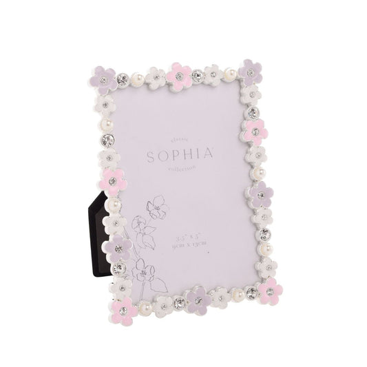 Introducing the Sophia Classic Daisy 3.5" x 5" Frame - Pastel, a delightfully charming piece that pairs perfectly with precious memories. Adorned with delicate white and pink flowers, it’s a treat for the eyes, while sparkling rhinestones add glamour.