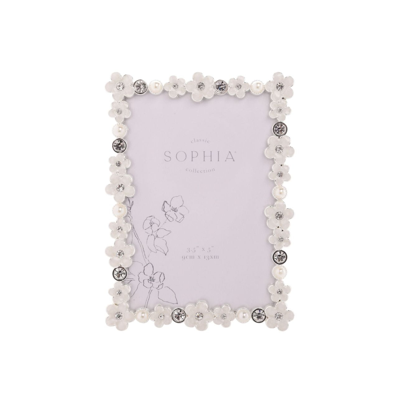 Introduce a touch of elegance and charm to your photo collection with the Sophia Classic Daisy 3.5” x 5” Frame in White. Featuring an intricate floral pattern and decorative crystals, this frame transforms your cherished memories into a stunning display piece that exudes sophistication.
