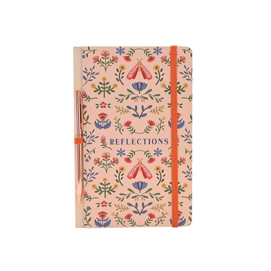 A floral-patterned notebook titled "Reflections" with an orange elastic closure pairs beautifully with a sleek pen, creating a set that's both useful and display-worthy. Jot down notes, memories, and dreams on smooth lined pages.