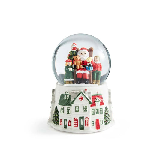 Step into a winter wonderland with this enchanting Christmas Tre Village Snow globe from Spode. Inside the glass globe, Santa Clause, laden with gifts, delights a group of children in a scene of pure holiday magic. 