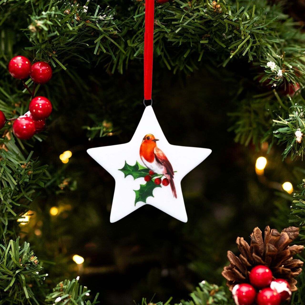 Elevate your holiday décor with the Gisela Graham Robin on Holly Christmas Hanging Ornament. This finely crafted piece features a delicate robin perched amidst vibrant holly leaves and berries, adding a touch of natural elegance to your Christmas tree.