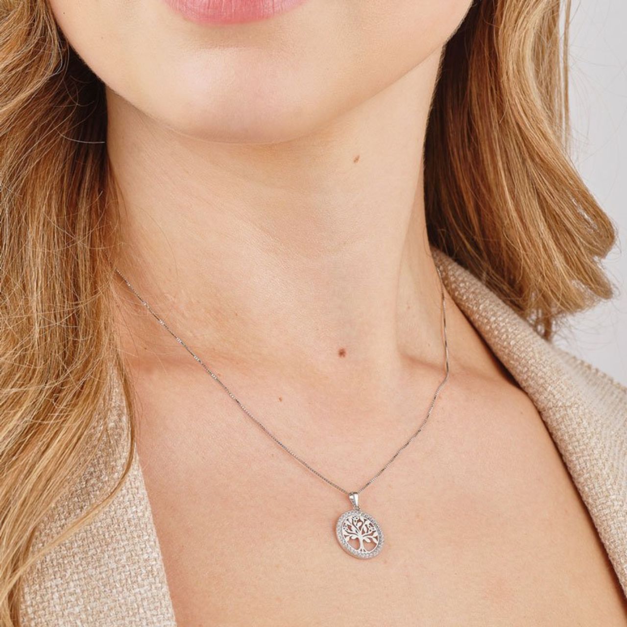 Sterling Silver CZ Round Tree Of Life Necklace  Crafted in sterling silver, this Tree of Life necklace sits in the centre of a ring of cubic zirconia. The Tree of Life is a famous Irish symbol which represents balance, harmony and rebirth. A chic look that will brighten up any neckline.