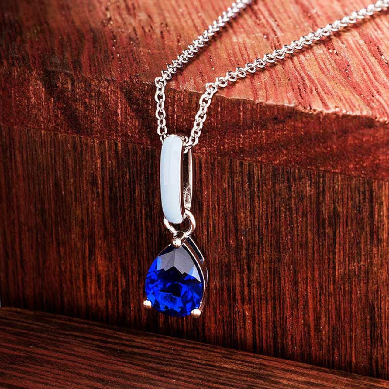 Elevate your elegance with the ShanOre Sterling Silver Necklace, featuring a stunning sapphire CZ centerpiece accented by delicate blue enamel detailing.