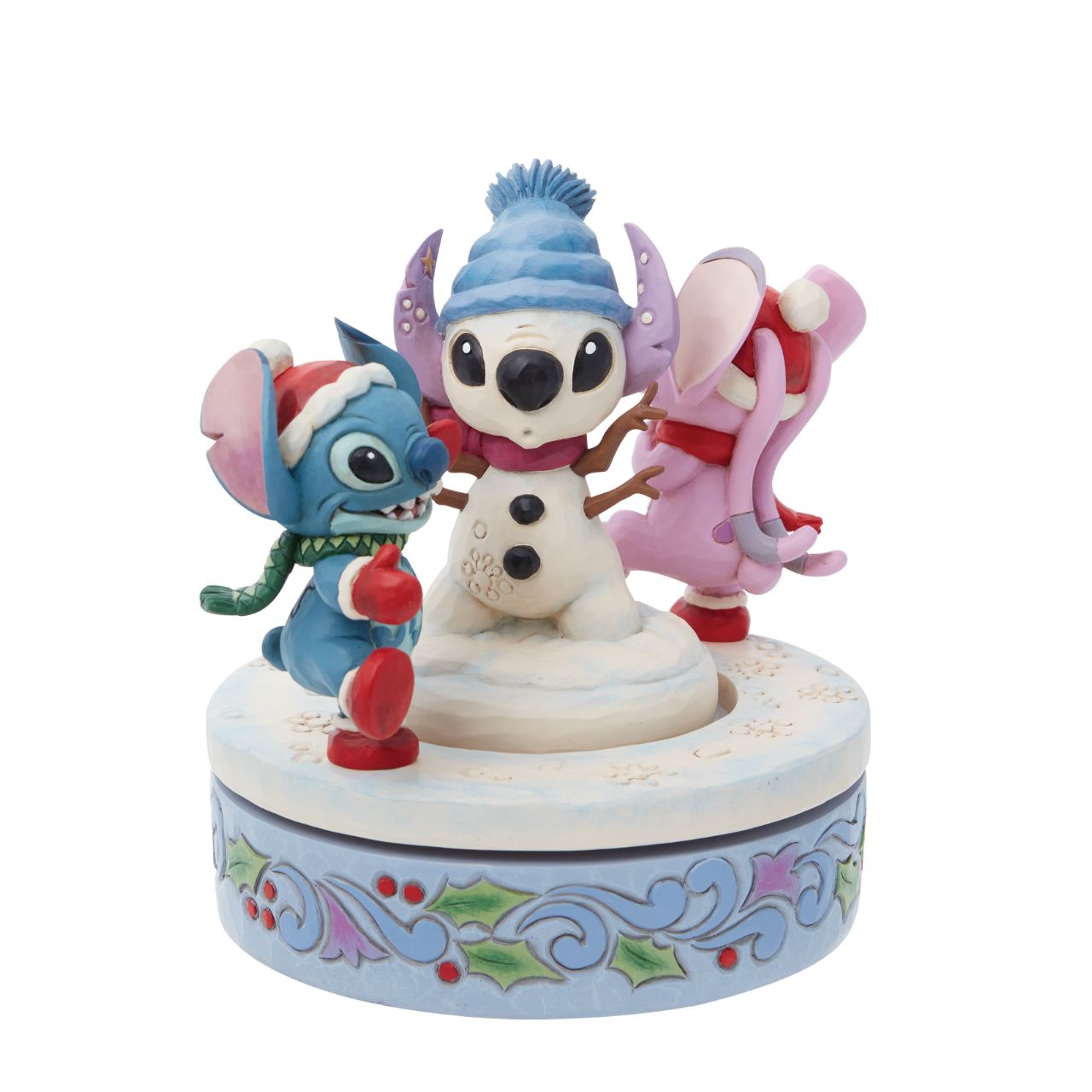 Disney Stitch & Angel Rotating Figurine by Jim Shore  Disney's Stitch and Angel are playing in the snow with their extra special Snowman this Christmas. Hand rotatable, they chase each other round and round. Designed by award winning artist Jim Shore, hand crafted from high quality cast stone and hand painted.