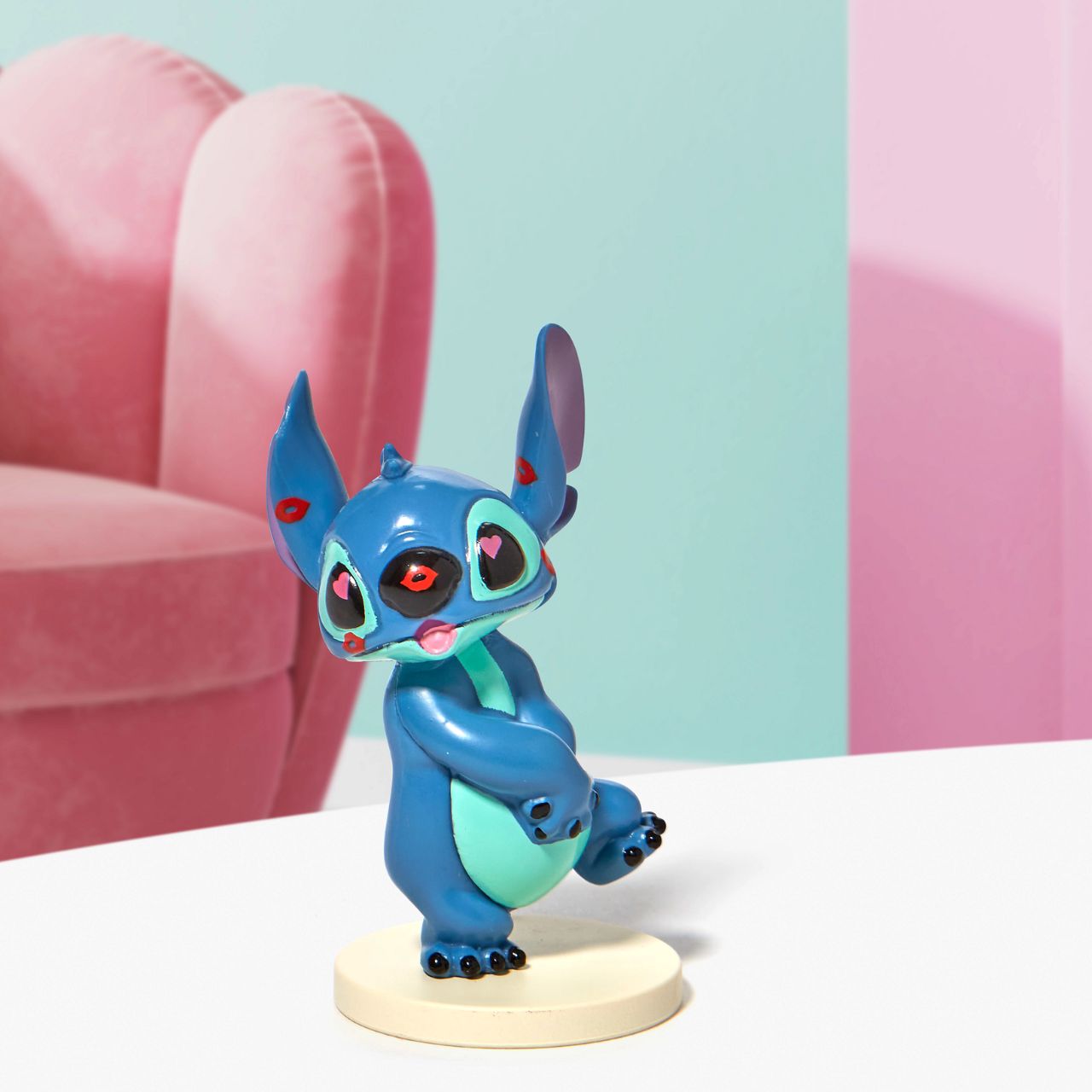 Grand Jester Stitch Covered in Kisses Mini Figurine  This super cute Stitch has been covered in lipstick kisses and looks loved up. He is made from high quality vinyl and is the perfect addition to any Stitch fans collection or bought as a gift for a birthday, Valentines or as a little treat.