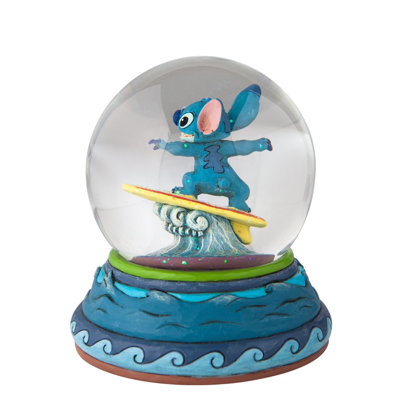 “Shootin’ the Curls” Stitch Snow Globe by Jim Shore  Stitch catches a wave inside your waterball! The Hawaiian adopted alien has learned a few things in his time on earth, among them playing the guitar and hanging ten. With striking form and colour, this Jim Shore design applauds the Disney film.
