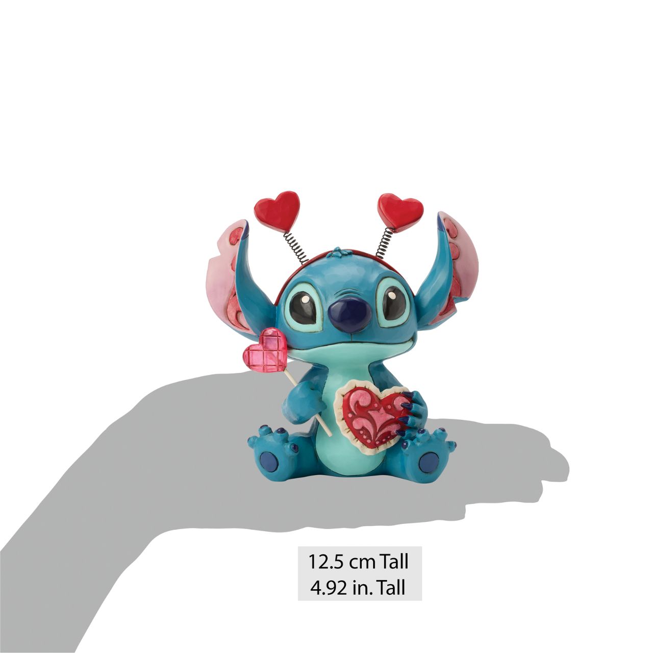 Stitch looks extra sweet in this Jim Shore creation, wearing a heart-topped headband and holding a heart-shaped lollipop.