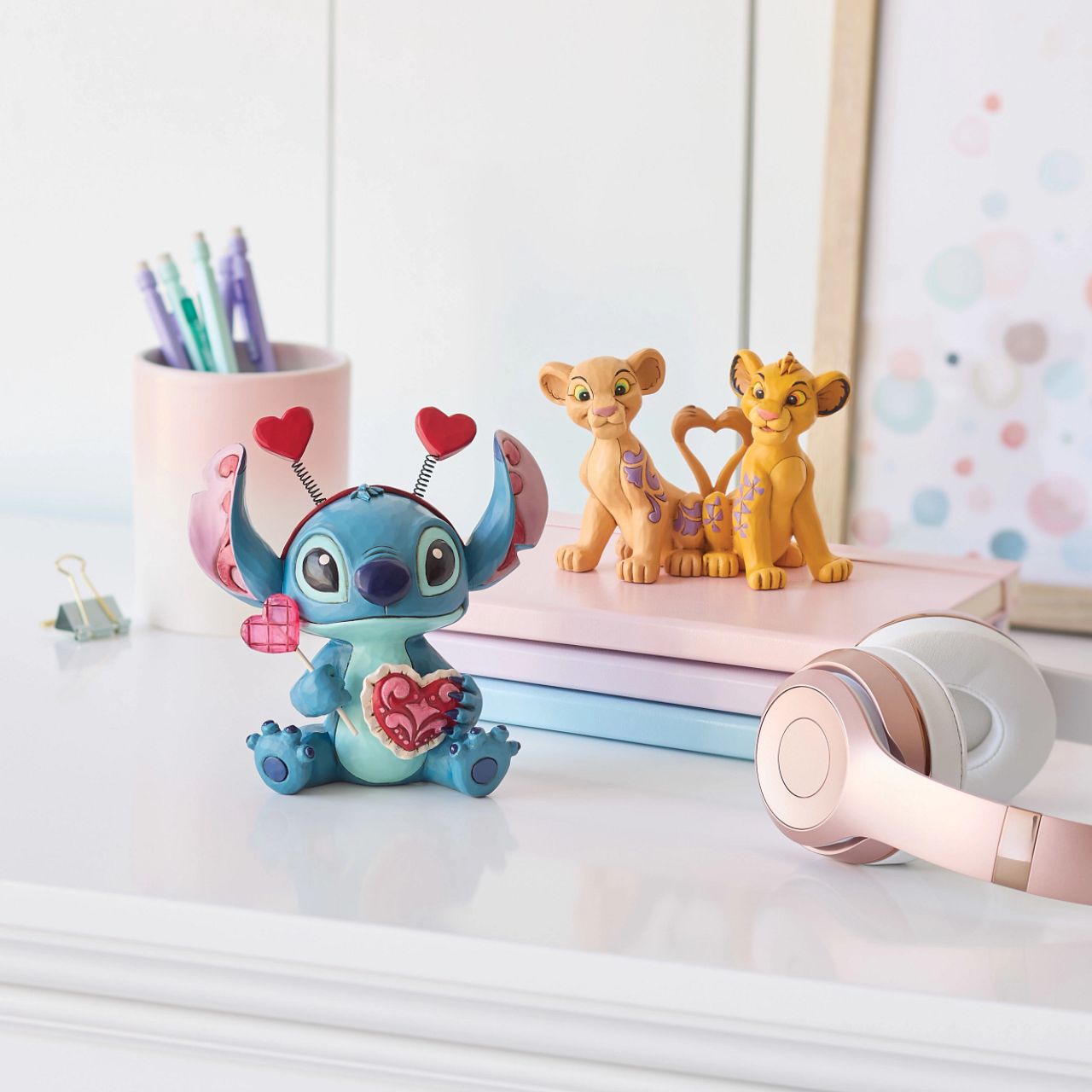 Stitch looks extra sweet in this Jim Shore creation, wearing a heart-topped headband and holding a heart-shaped lollipop.
