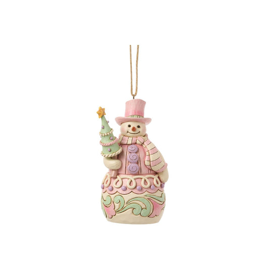 Bundled up for the season, this snowman ornament carries a decorated Christmas tree in his arms. Jim Shore's intricate designs swirl across his coat, adding heart-warming detail to this classic winter character. A joyful symbol of holiday sweetness.