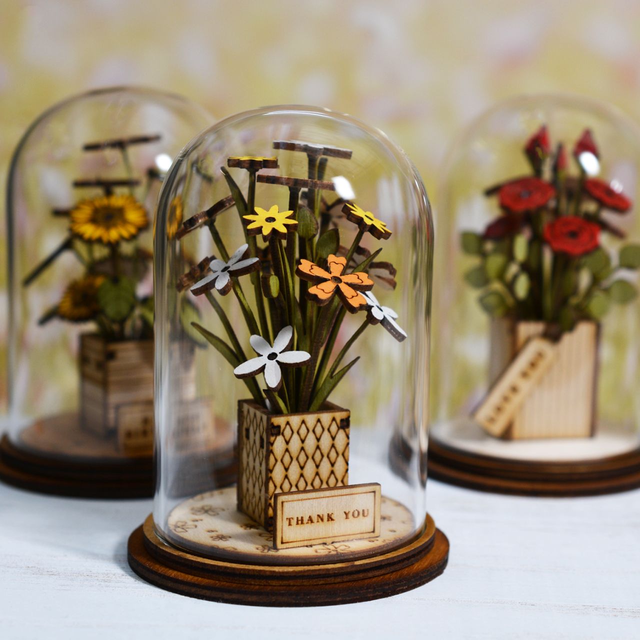 Say Thank You with this beautiful floral gift. This eco-friendly glass dome decoration encases a bunch of stunning yellow and white flowers, adorned with a Thank You plaque.
