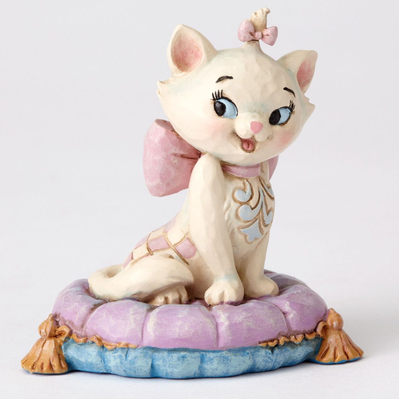 Jim Shore The Aristocats Marie on Pillow Mini Figurine  Beautifully crafted with delightful attention to detail, Jim Shore's charming miniatures capture the essence of the beloved Disney characters. Beguiling Marie poses on a purple pillow in this light-hearted scene from the classic film The Aristocats.