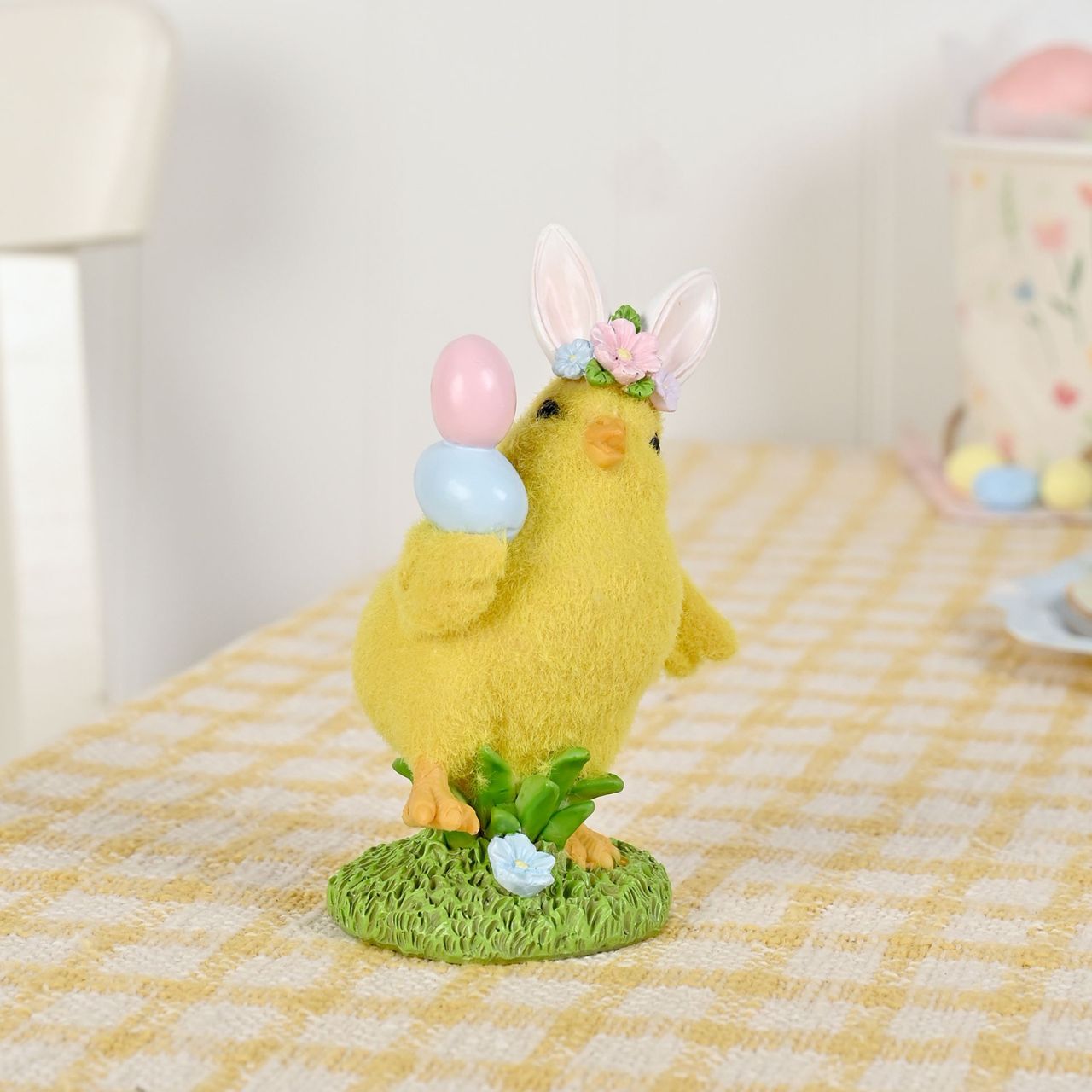 The Easter Chick With Bow Figurine from The Eggs-traordinary Gifting Co is a bright seasonal accent designed to stand out in Easter ranges.