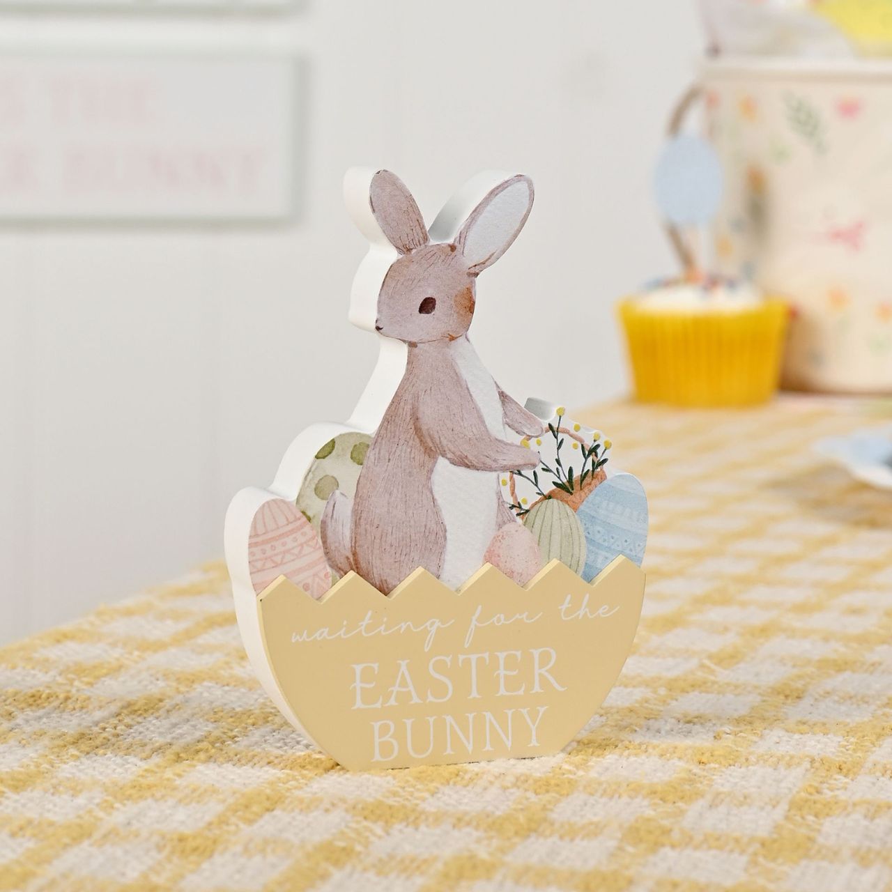 The Eggs-traordinary Gifting Co ‘Waiting For The Easter Bunny’ Plaque is a characterful decorative accent designed for seasonal displays.