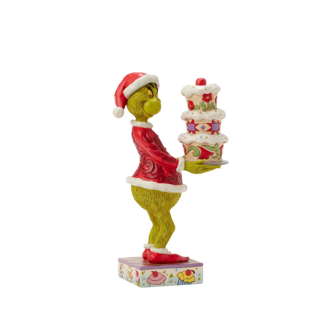 Disguised as Santa, The Grinch beams with trickery as he steals a towering cake. Adorned with Jim Shore's iconic rosemaling, patchwork patterns, and charming floral details, this piece captures the mischief of Christmas in true Grinch fashion.