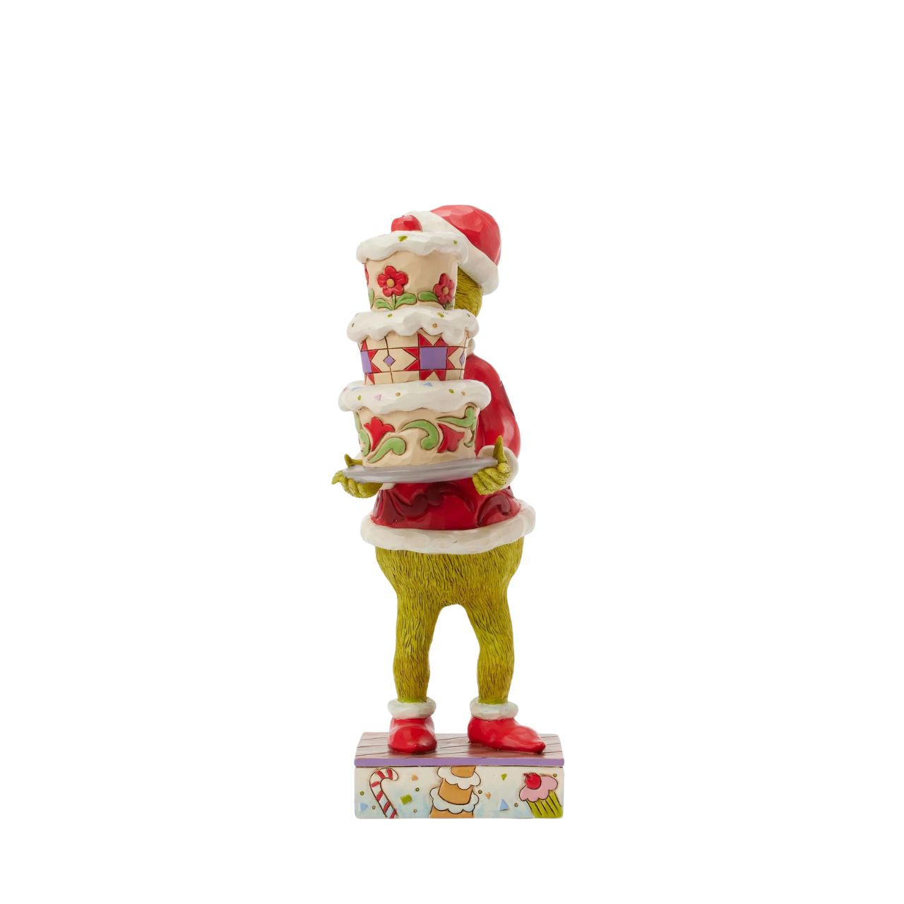 Disguised as Santa, The Grinch beams with trickery as he steals a towering cake. Adorned with Jim Shore's iconic rosemaling, patchwork patterns, and charming floral details, this piece captures the mischief of Christmas in true Grinch fashion.