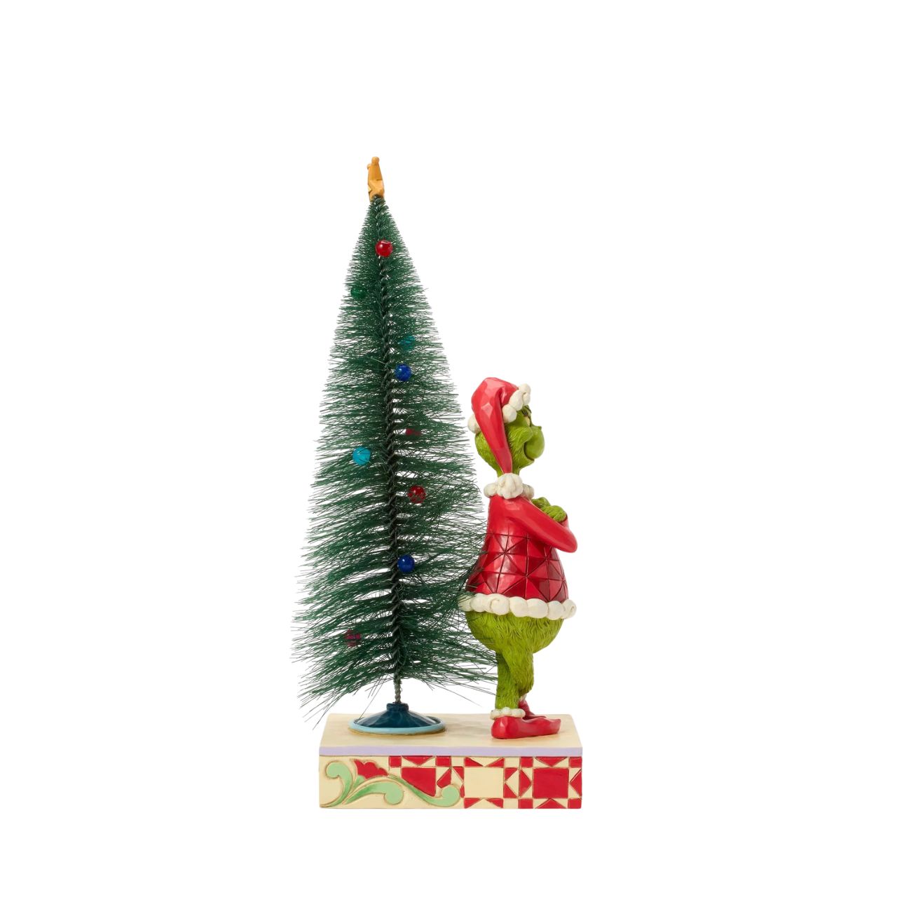 This playful Jim Shore design features The Grinch, arms crossed with a smirk, exuding snarky attitude as he stands beside a beautiful sisal tree with vibrant ball ornaments. Bring mischief home with Jim Shore's intricate detailing and rich colours.