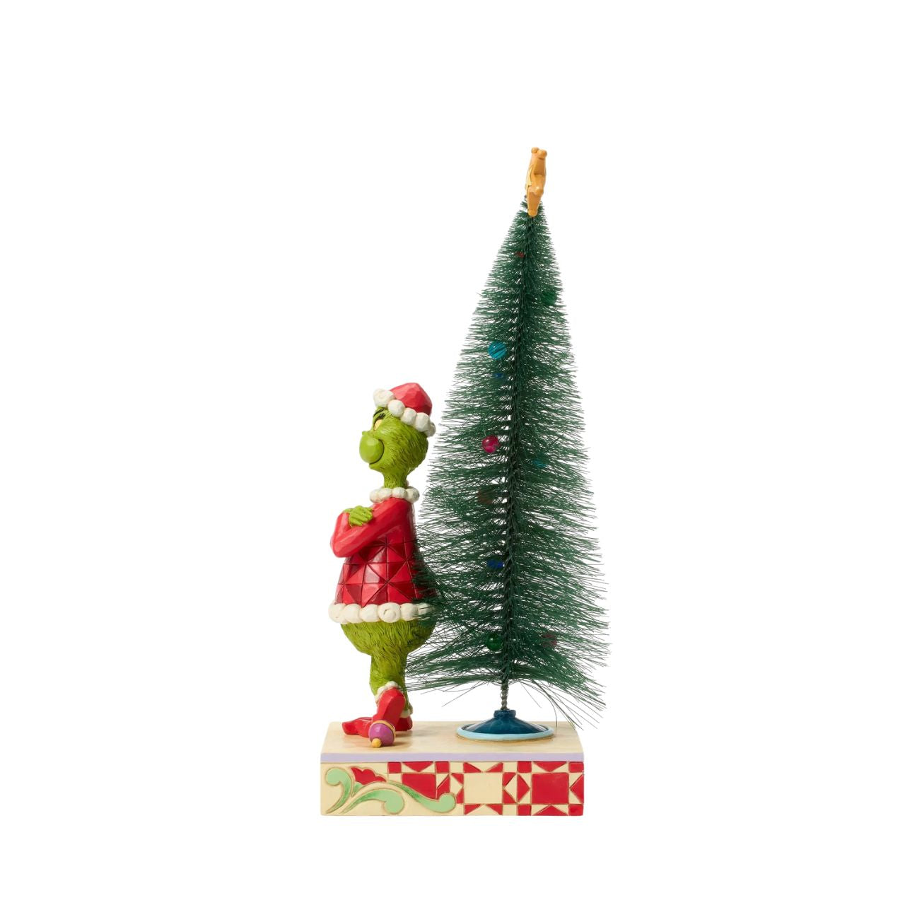 This playful Jim Shore design features The Grinch, arms crossed with a smirk, exuding snarky attitude as he stands beside a beautiful sisal tree with vibrant ball ornaments. Bring mischief home with Jim Shore's intricate detailing and rich colours.