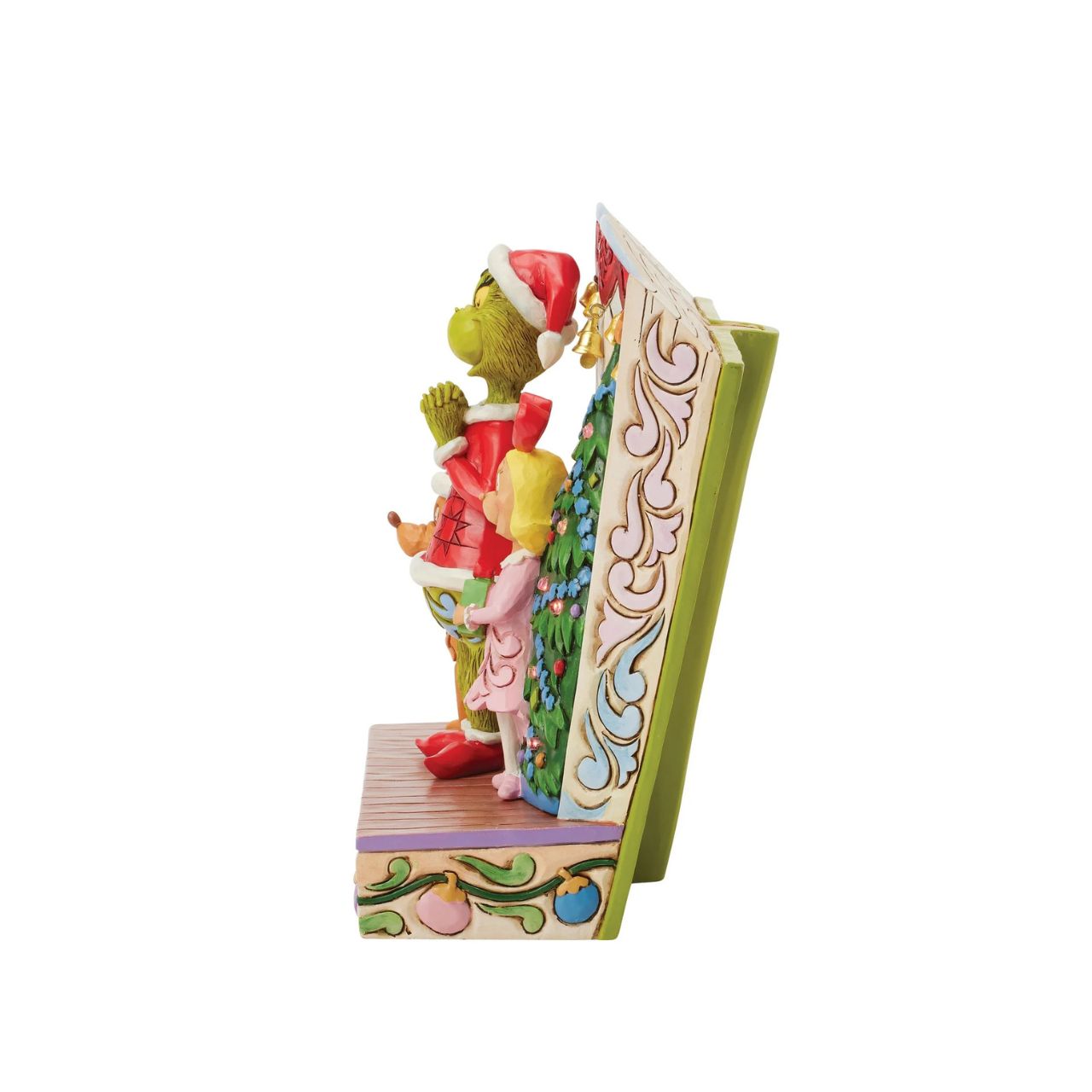 Framed within the classic Dr. Seuss book, this Jim Shore piece captures The Grinch's heartwarming transformation with Cindy Lou and Max by his side. Dressed as Santa, he smiles with rosemaling, patchwork patterns, and real jingle bell details.