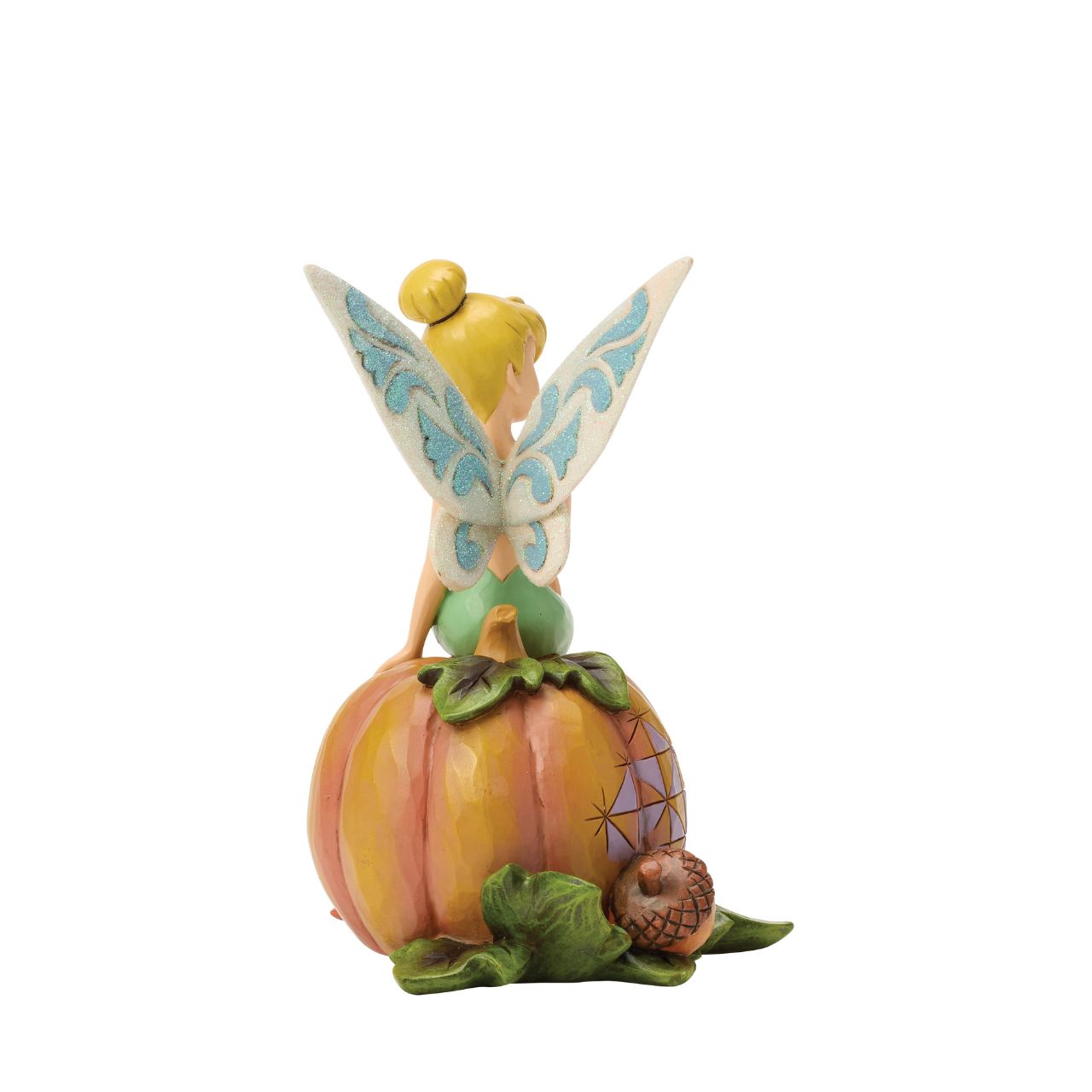 Tinker Bell adds a touch of pixie dust to Halloween magic in this charming Jim Shore design. Dressed in festive autumn colours, she sits gracefully on a pumpkin, blending Disney whimsy with folk-art charm.