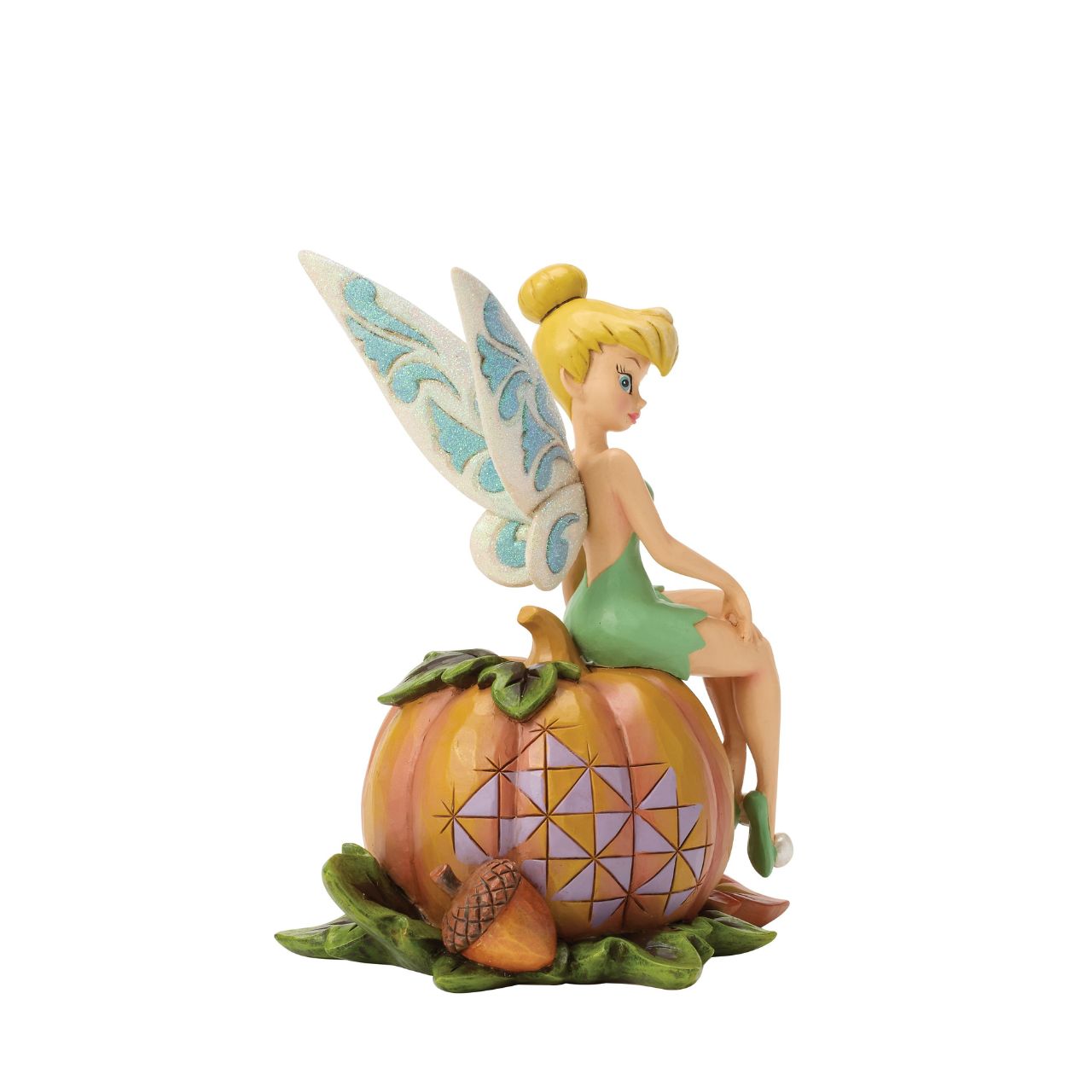 Tinker Bell adds a touch of pixie dust to Halloween magic in this charming Jim Shore design. Dressed in festive autumn colours, she sits gracefully on a pumpkin, blending Disney whimsy with folk-art charm.