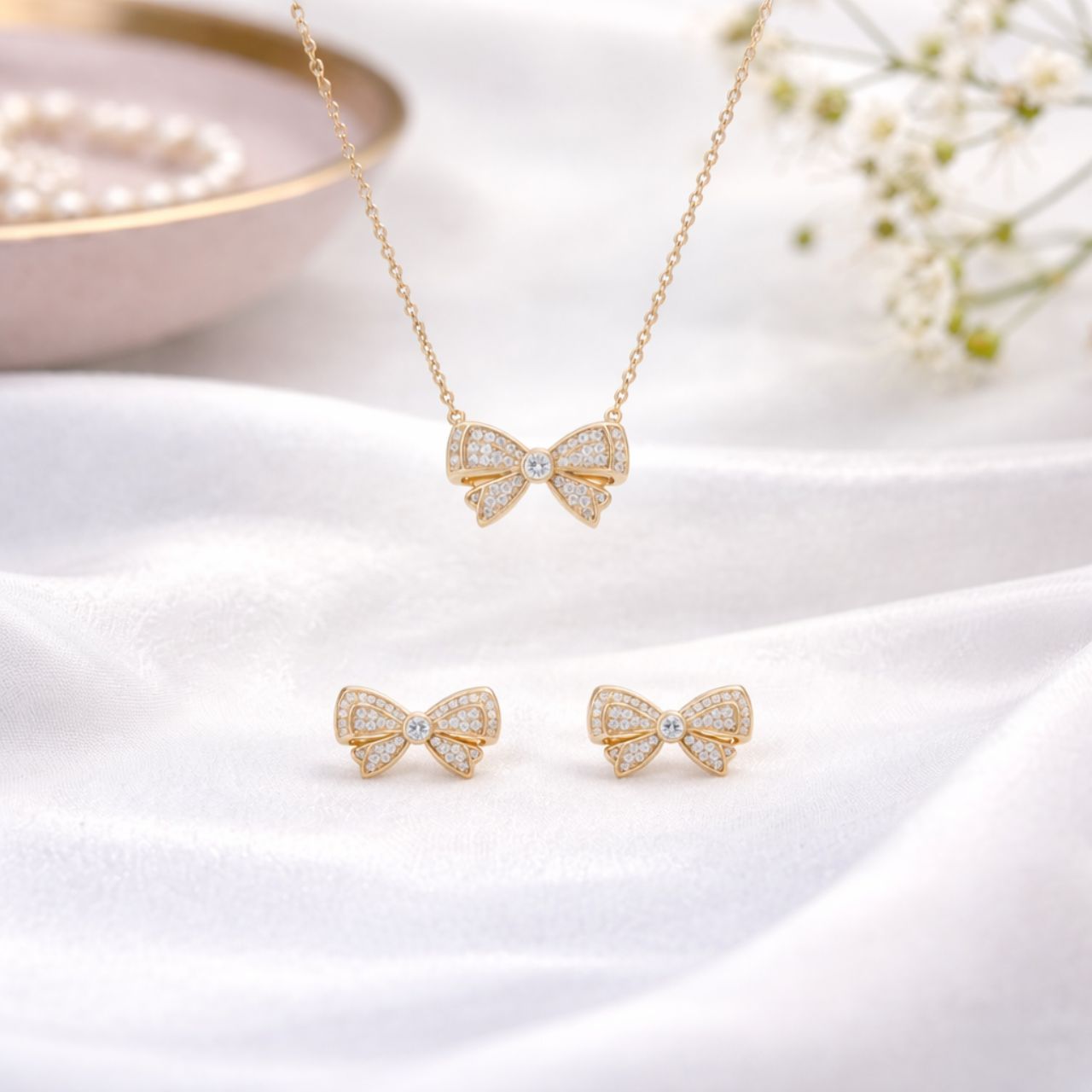 Elegant double bow earrings crafted in gold plated with sparkling cubic zirconia insets. These charming studs combine classic design with contemporary sparkle, perfect for adding a touch of sophistication to any occasion.