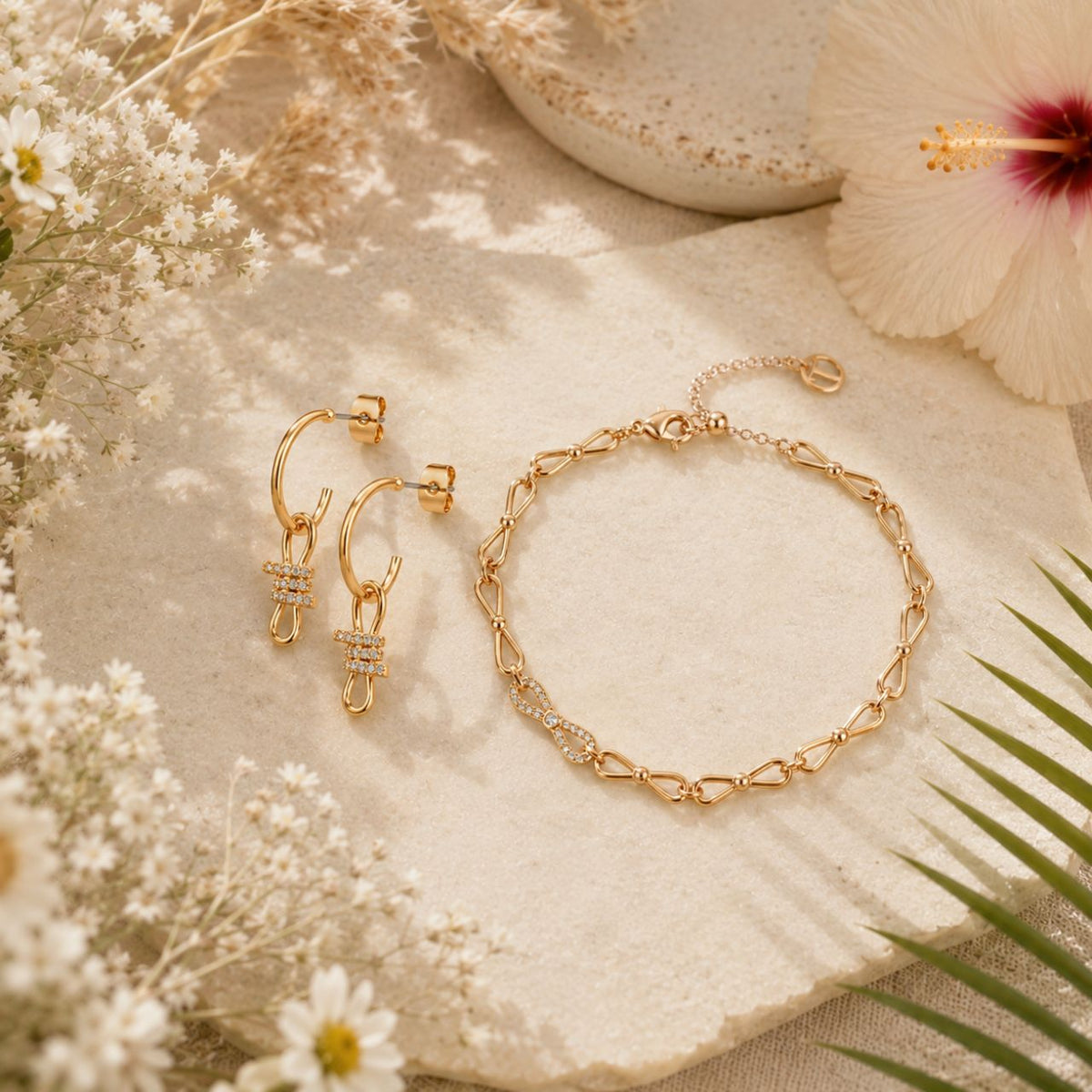 Elegant bow-shaped drop huggie earrings crafted in gleaming gold plated by Tipperary. These delicate earrings combine timeless design with contemporary style, featuring a charming bow motif that catches the light beautifully.