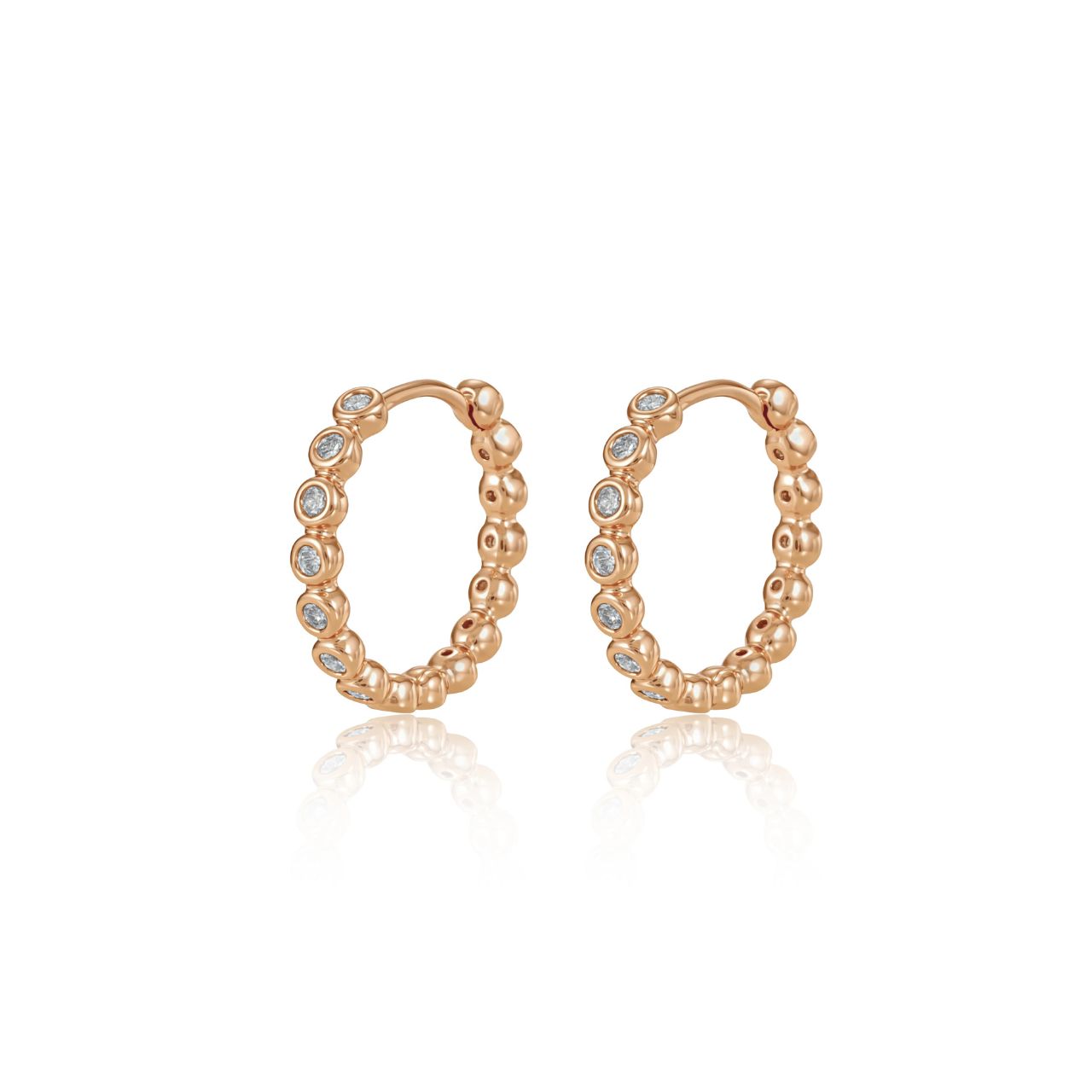 Elegant circle hoop huggies crafted with lustrous gold finish and adorned with sparkling cubic zirconia stones.