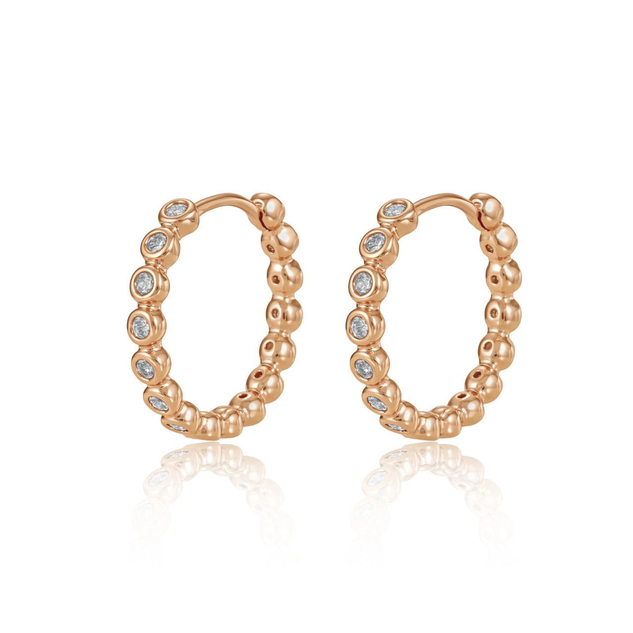 Elegant circle hoop huggies crafted with lustrous gold finish and adorned with sparkling cubic zirconia stones.