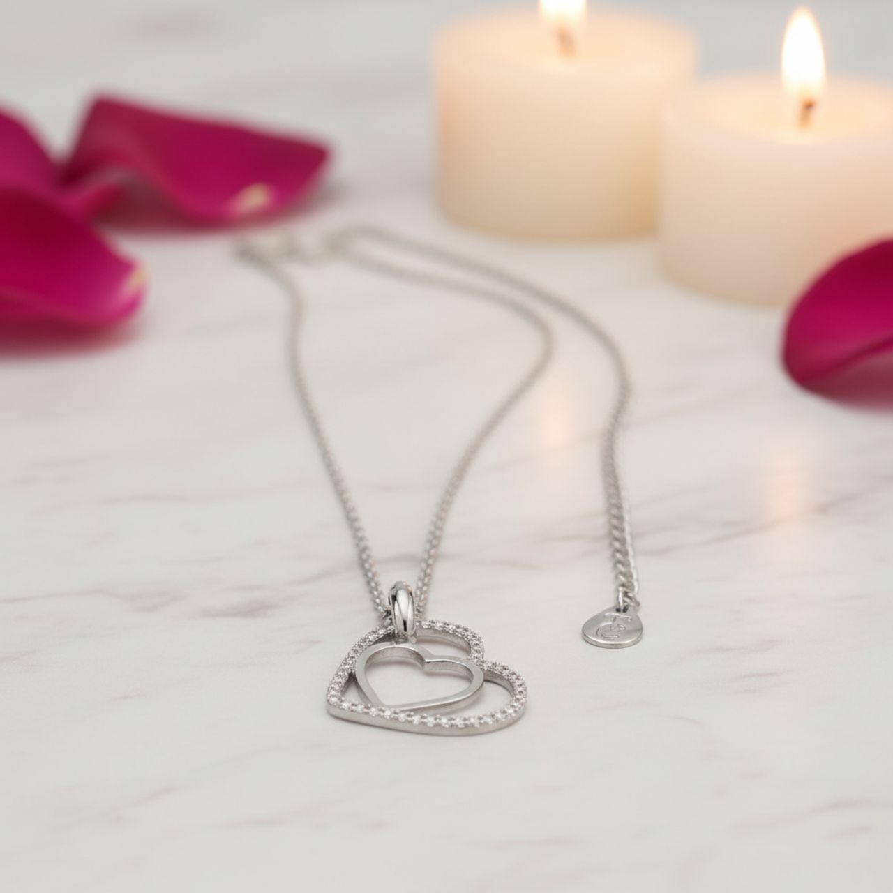 Especially for the one you love this meaningful design is styled in sleek silver. It features two open hearts - one smaller polished silver heart set inside the larger outline heart with a glittering border of clear crystal accents.