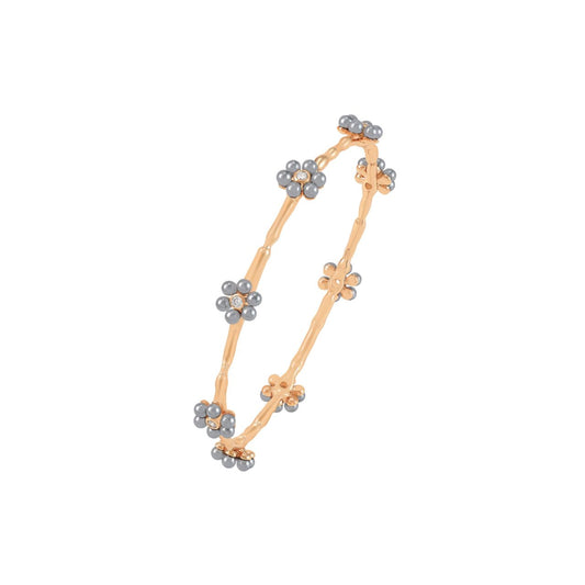 Delicate and refined, the Daisy Grey Pearl Bangle brings a fresh twist to a timeless floral design. Inspired by the beauty of blooming daisies, this piece combines feminine charm with a touch of modern elegance, making it a standout accessory for any occasion.
