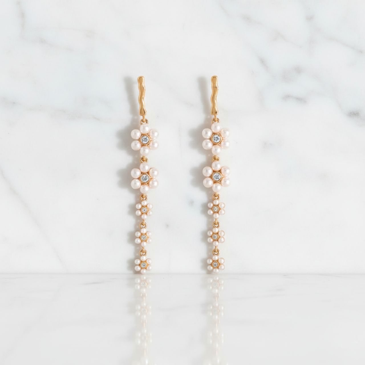 Delicate and graceful, the Daisy Pink Pearl Drop Earrings are a romantic statement piece from the Daisy Collection. Inspired by the natural charm of blooming flowers, they bring a soft, feminine elegance to your look.