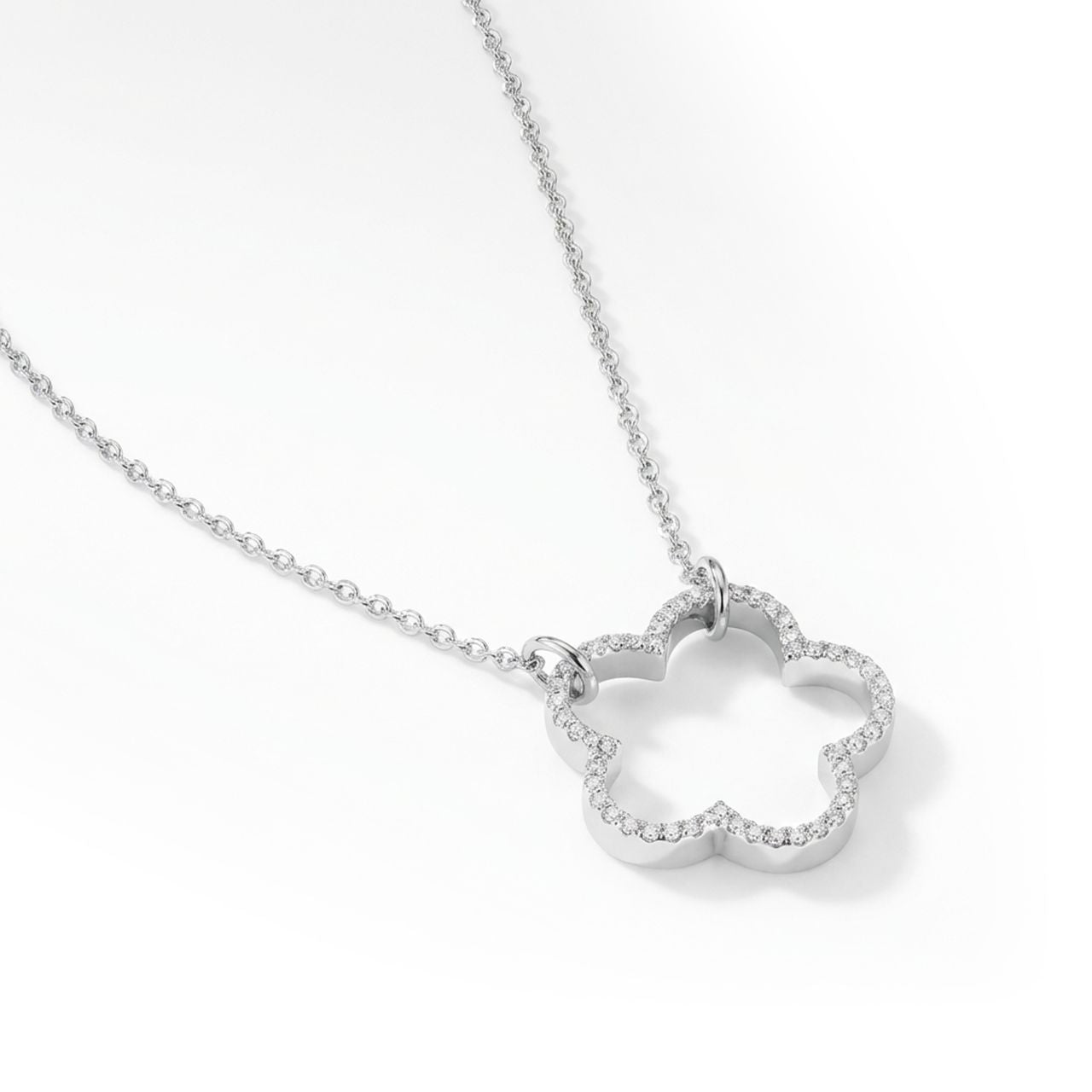 Discover the timeless elegance of the Tipperary Fleur CZ Inset Cut Out Pendant in sterling silver. This exquisite piece features an intricate cut-out fleur design adorned with sparkling cubic zirconia insets that catch the light beautifully.