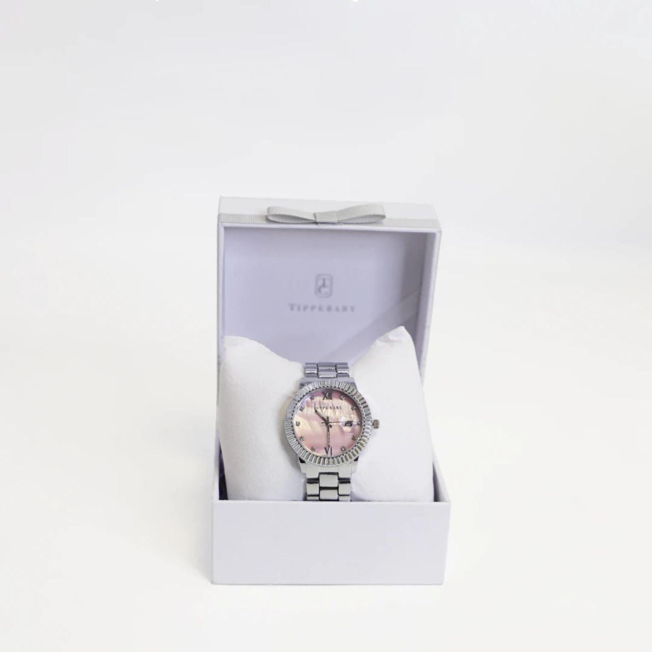 Crafted by the designers at Tipperary, This stunning timepiece features a sleek silver-tone case and band, beautifully complemented by a pearl pink dial.