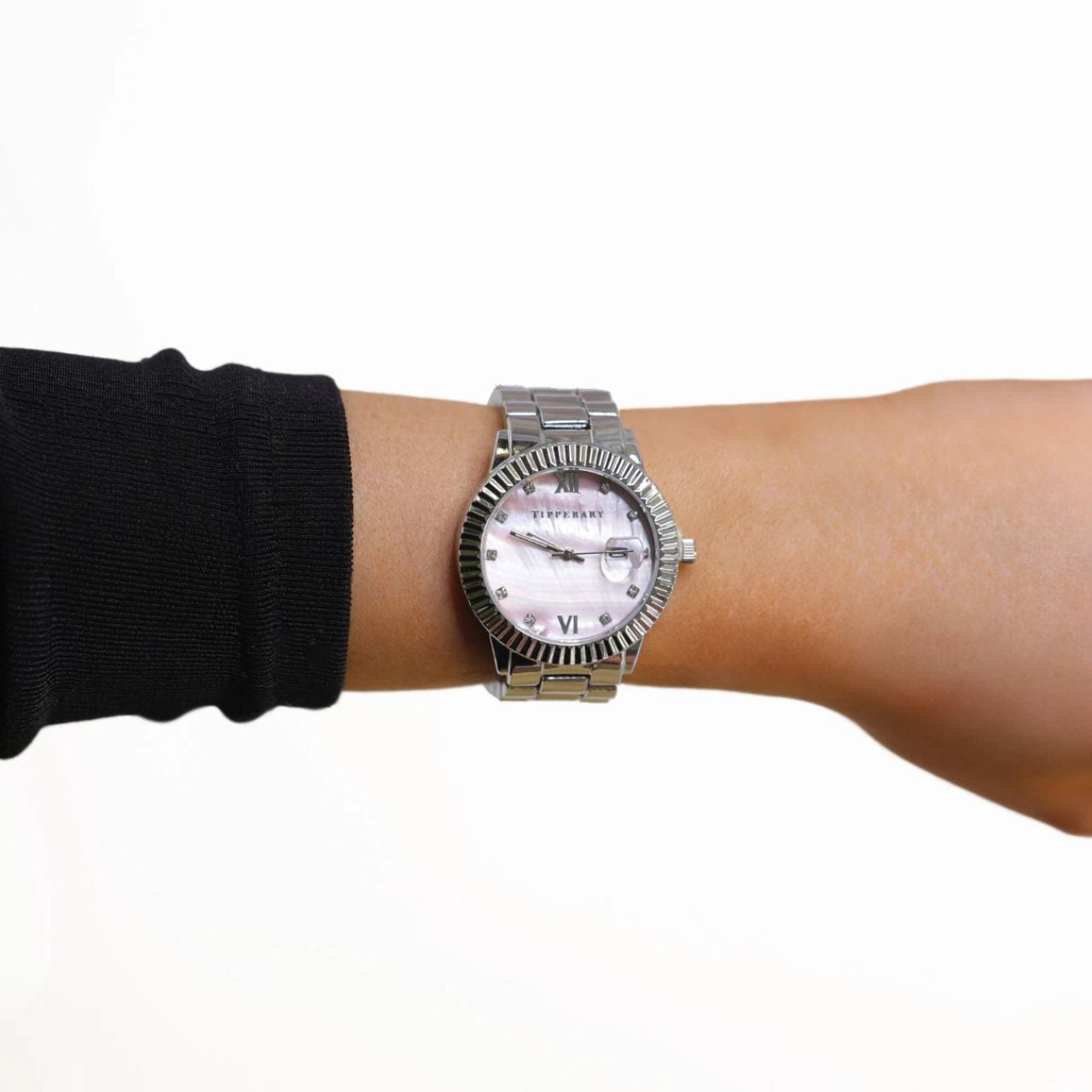 Crafted by the designers at Tipperary, This stunning timepiece features a sleek silver-tone case and band, beautifully complemented by a pearl pink dial.