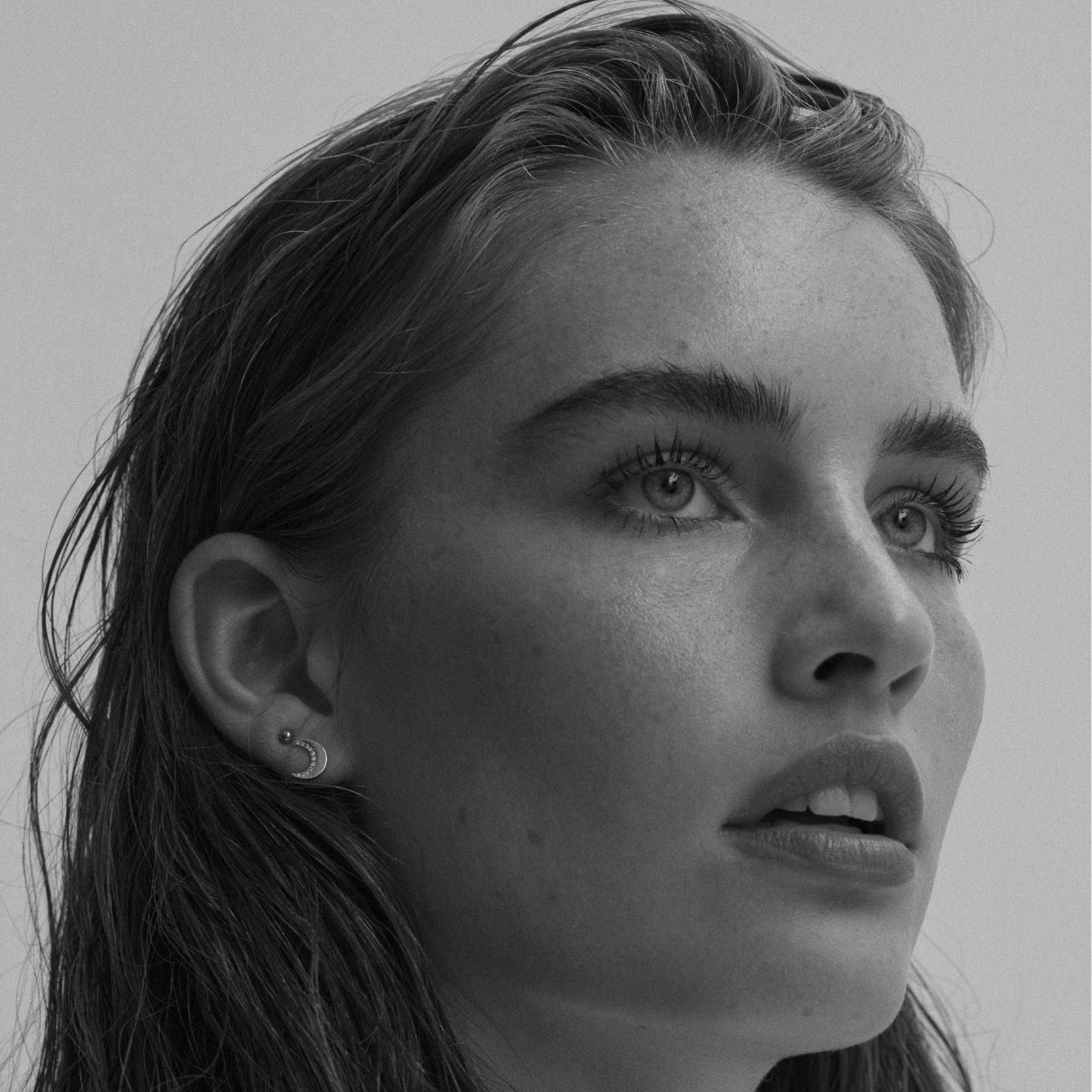 Half Moon Stud Rose Gold Earrings by Tipperary  Inspired by the hypnotic energy of the glowing moon, this collection is contemporary and minimalist yet luxuriously adorned with the clearest sparkling stones.