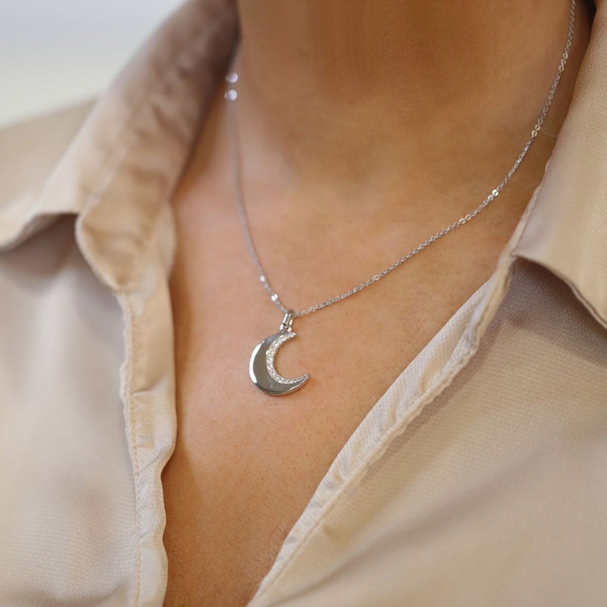 This beautiful half moon Pendant is crafted from Silver and feature a semi pave set half moon icon, the half moon is attached to a delicate chain by a highly polished bale that slides freely. This pendant closes with a lobster clip and is finished with a TC Fob.